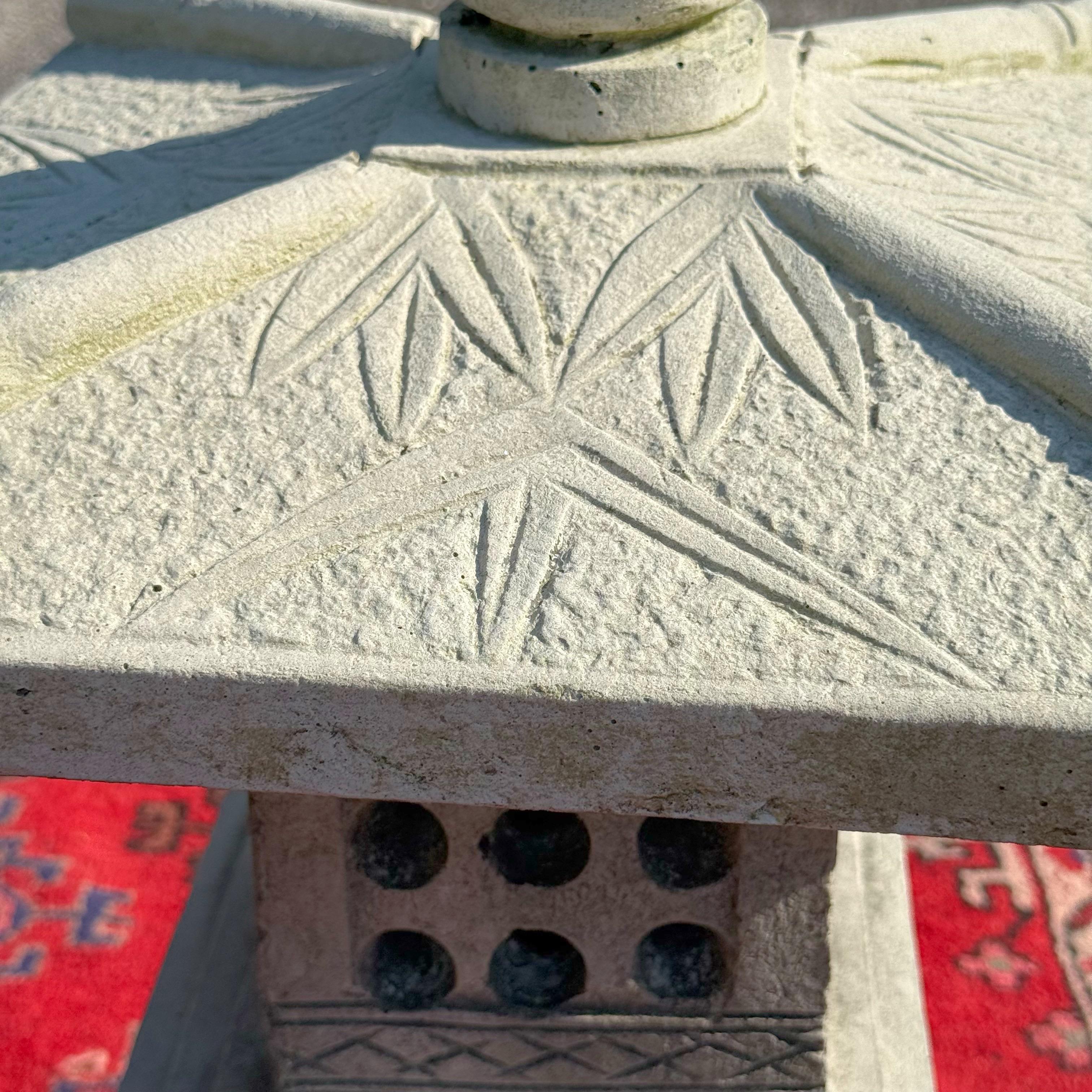 Fabulous vintage cast cement pagoda. Beautiful patina from time on this stunning outdoor sculpture. Fantastic bamboo shoots and leaves on the top portion with a lotus for the finial.  Breaks apart into stacking pieces for easy movement. Acquired