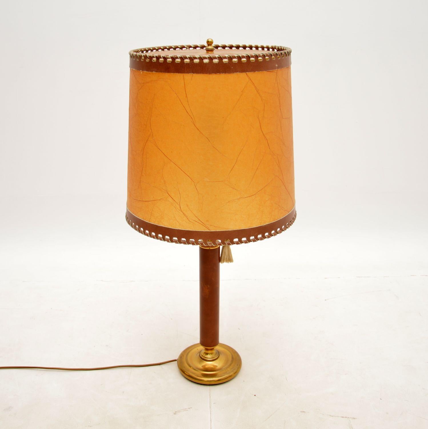 A very large and impressive vintage leather and brass table lamp. This was made in France, it dates from around the 1970’s.

The quality is outstanding, this has a solid brass frame which is clad in high quality brown leather. The shade is