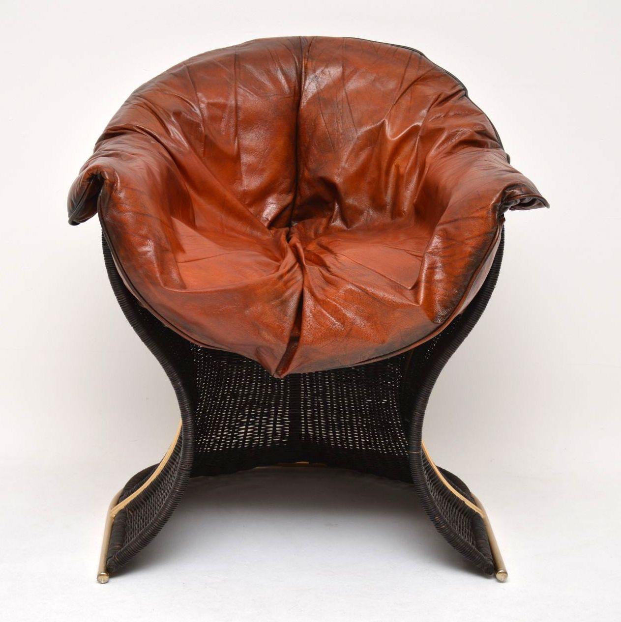 A very rare and unusually designed chair by Pieff of Worcester, this is called the Venus chair. It has an extremely well made wicker and brass frame, and removable leather cushions. The condition is excellent for its age, we have had the leather