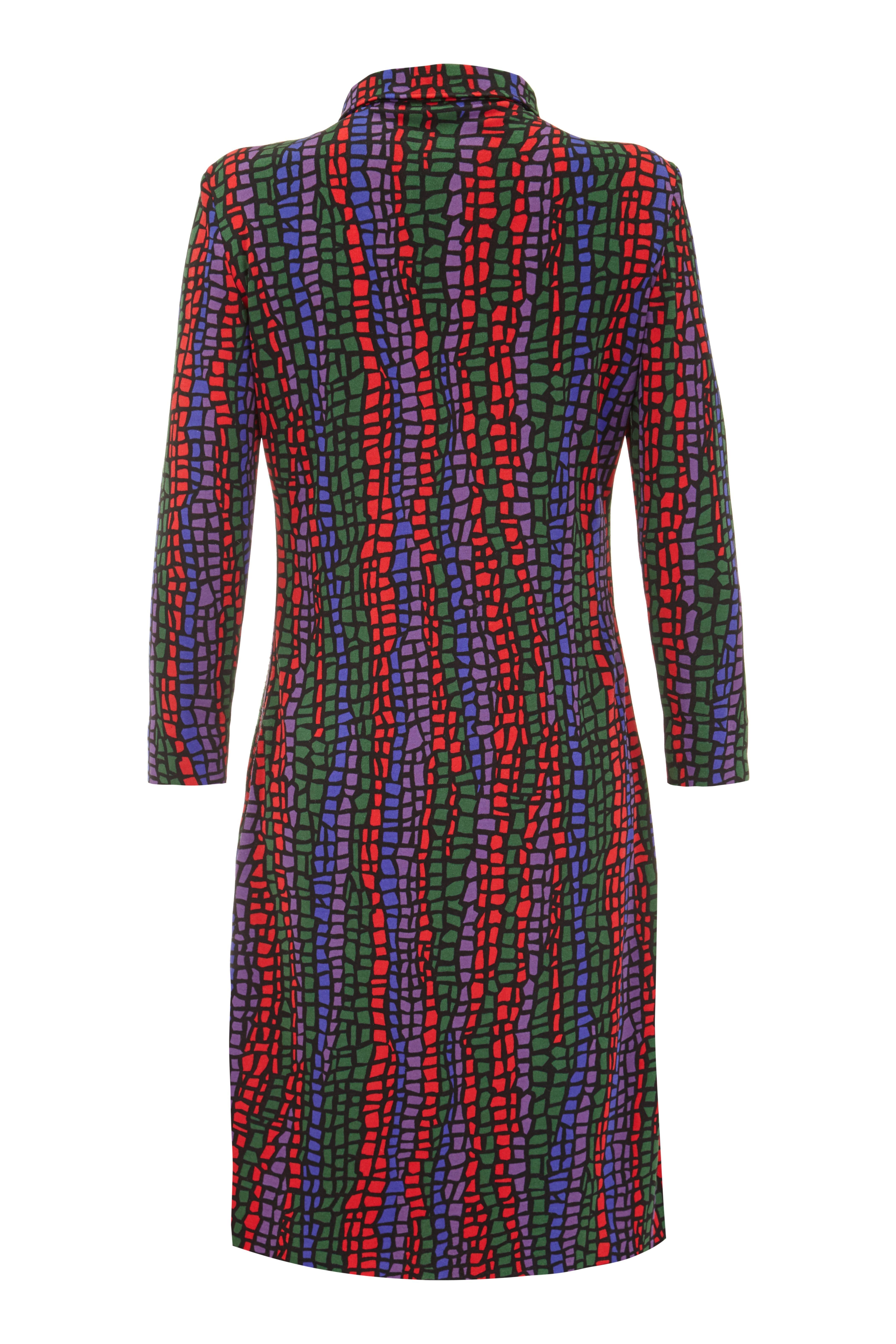 This stylish vintage 1970s silk jersey dress from Nini Capucci and designed in collaboration with Leonard of Paris features a vibrant red, green, purple and blue abstract 'stained glass' effect print. There are lucite button fastenings at the front