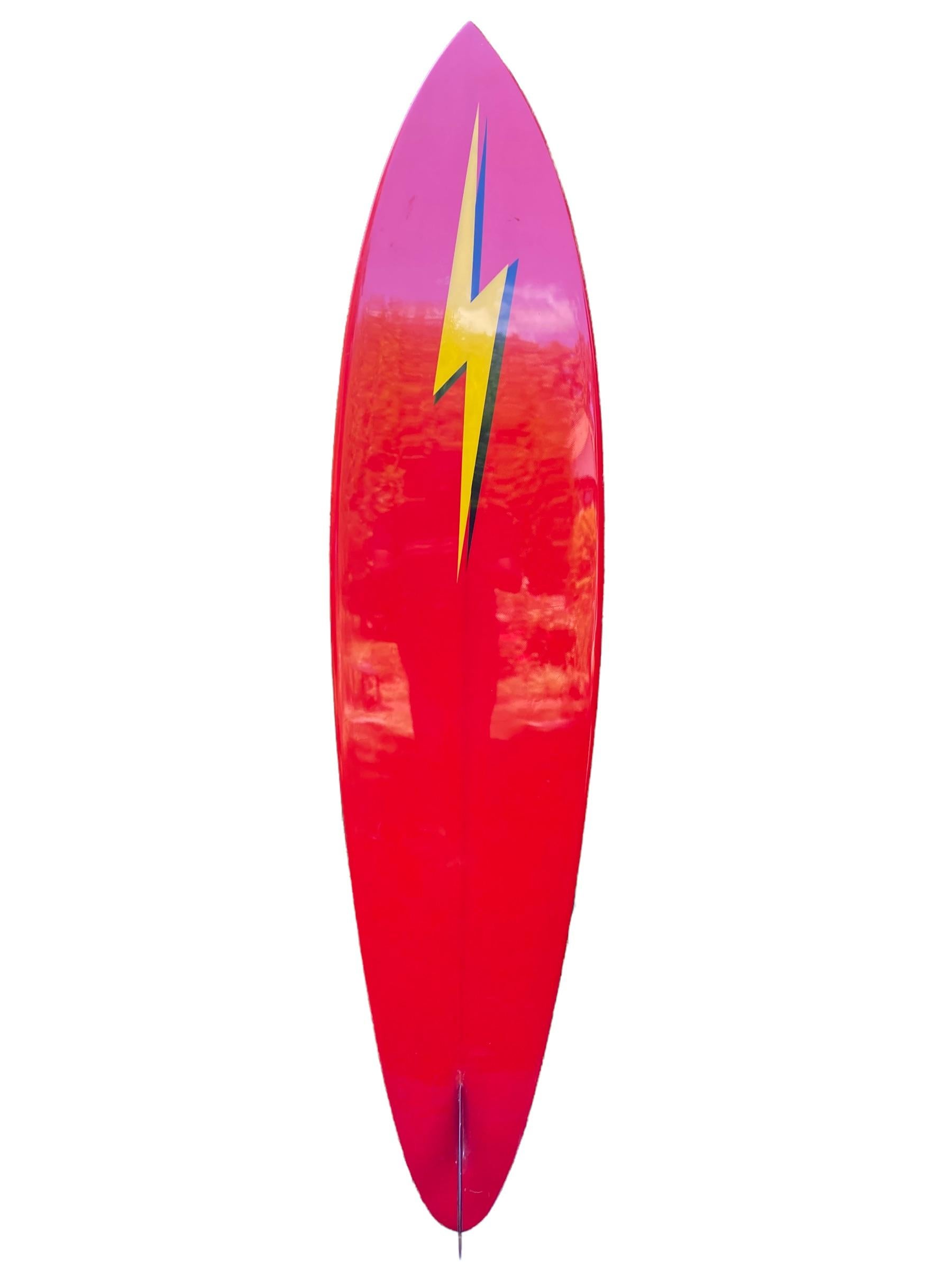 Early-1970s Lightning Bolt surfboard made by Bill Barnfield. Features a roundpin shape with vibrant yellow and red colors and glassed-on single fin. A remarkable example of a restored early 1970s vintage Lightning Bolt surfboard. 

In 1972, Gerry
