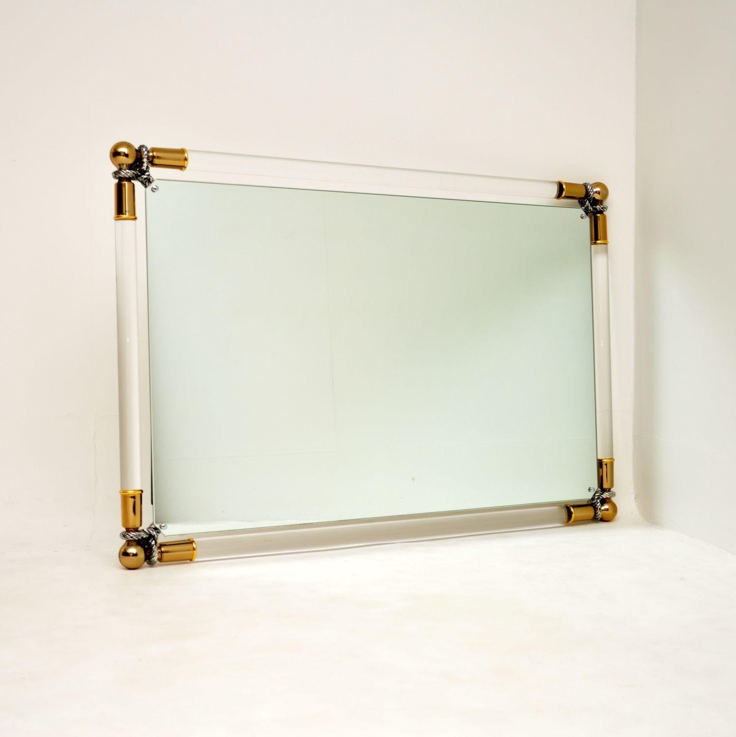 A beautiful and very impressive mirror, made in Spain by Curvasa, this dates from the 1970’s.

It is a fantastic size and is of amazing quality. The main frame is clear lucite, the corners are finished in gold and silver leaf.

This is in superb