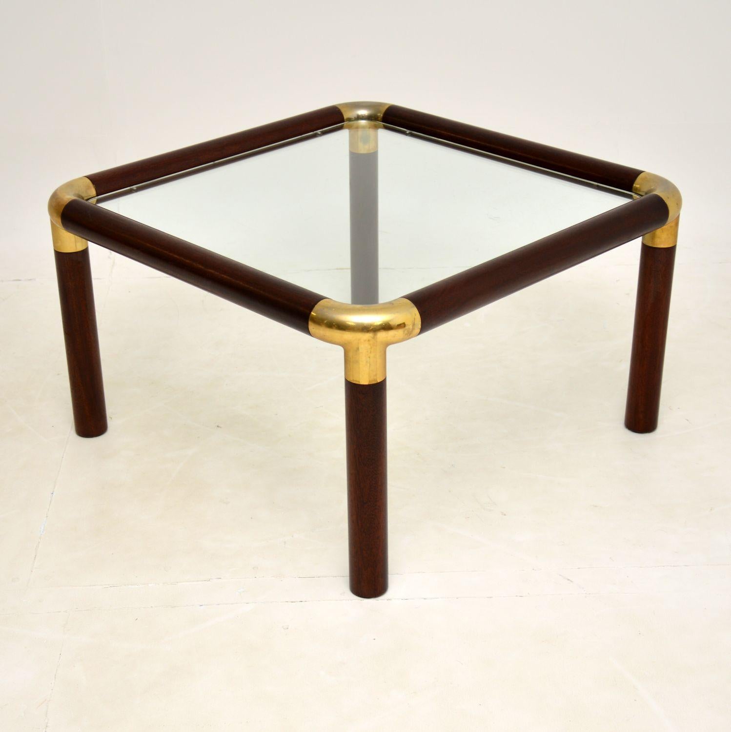 A superb vintage coffee table, beautifully made from solid wood and brass. This was made in England, it dates from around the 1970’s.

The quality is amazing, this has a thick and very well made tubular frame, and a thick inset glass top that is