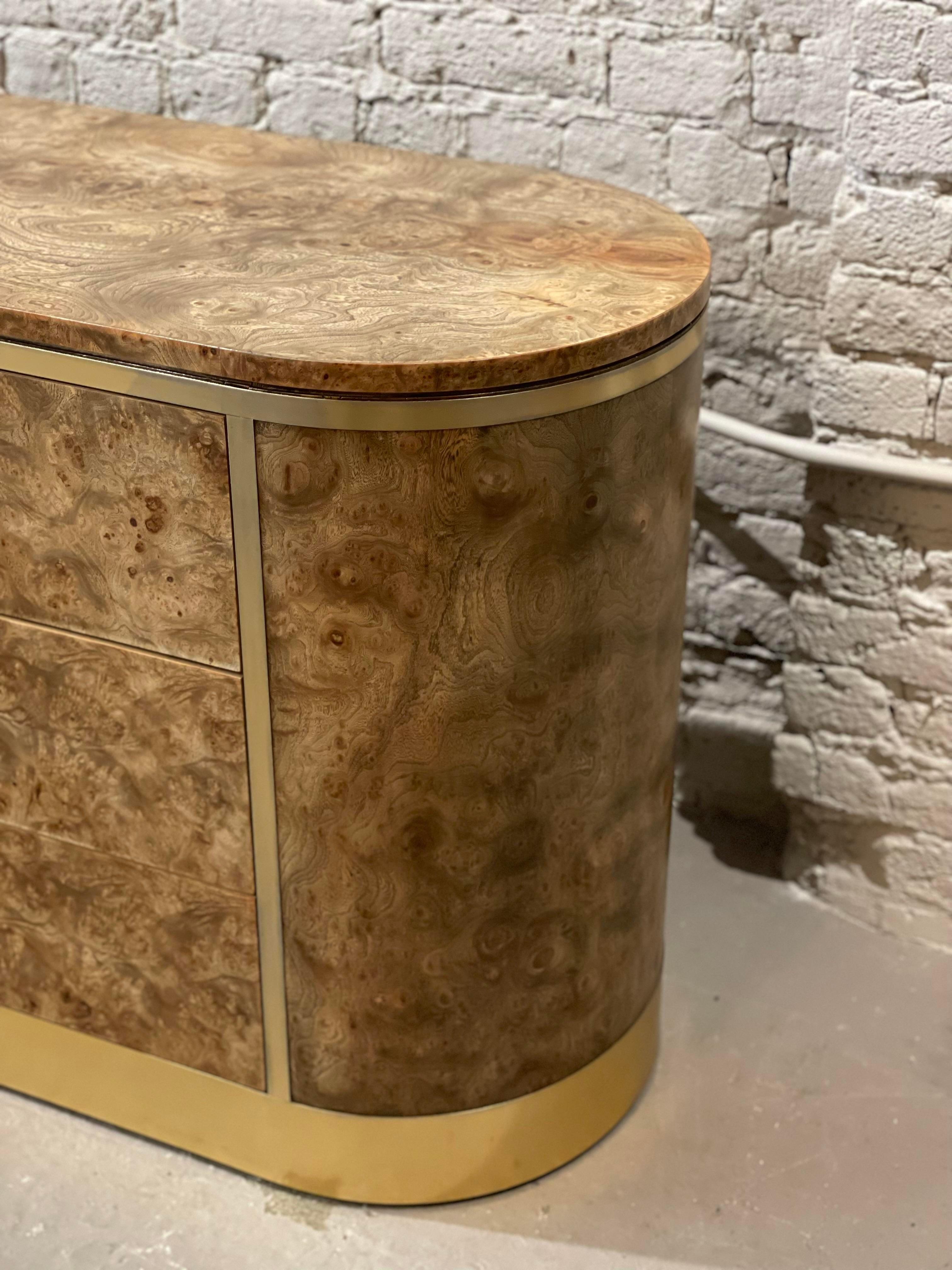 Oh I don’t want to sell this!! We sanded it down to see what was underneath the original polyurethane coating. It was the most beautiful natural color of Burled Wood. We simply put a matte sealant on it, polished up the brass and here it is!!