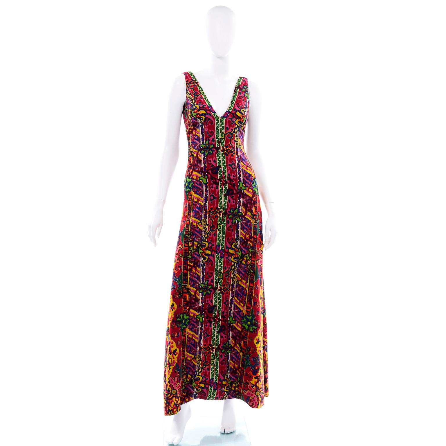 This is an exceptional vintage 1970's maxi dress from Bendel's Studio. The dress is in a woven textured paisley fabric in shades of pink, red, green, yellow, blue, white and burgundy. The dress is sleeveless with a v neck and low v back. The iconic