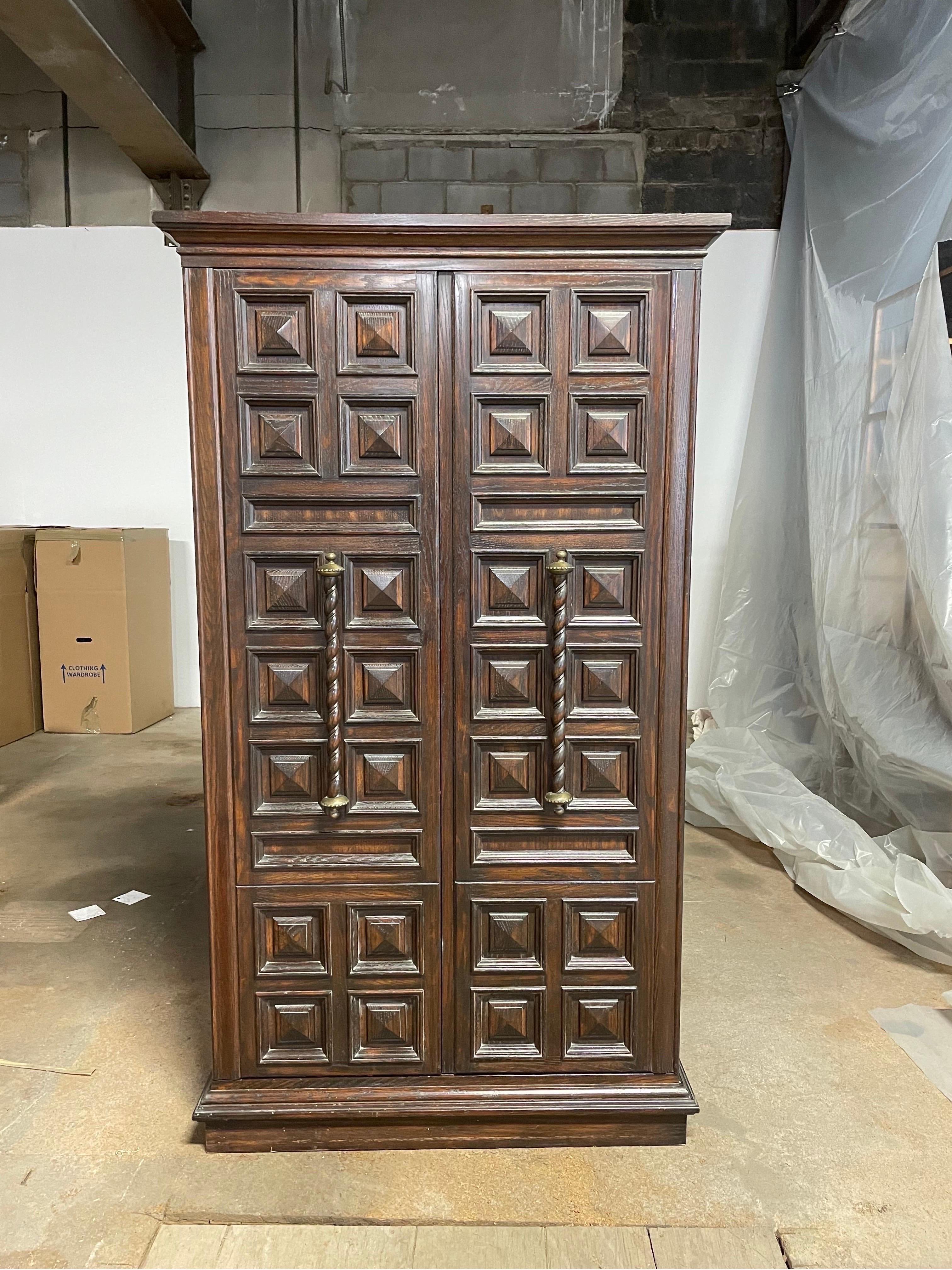 Wonderful stylized Mediterranean Armoire. Deep raised tufted panels and scrolled pulls. Ample storage with extending hanging rod.