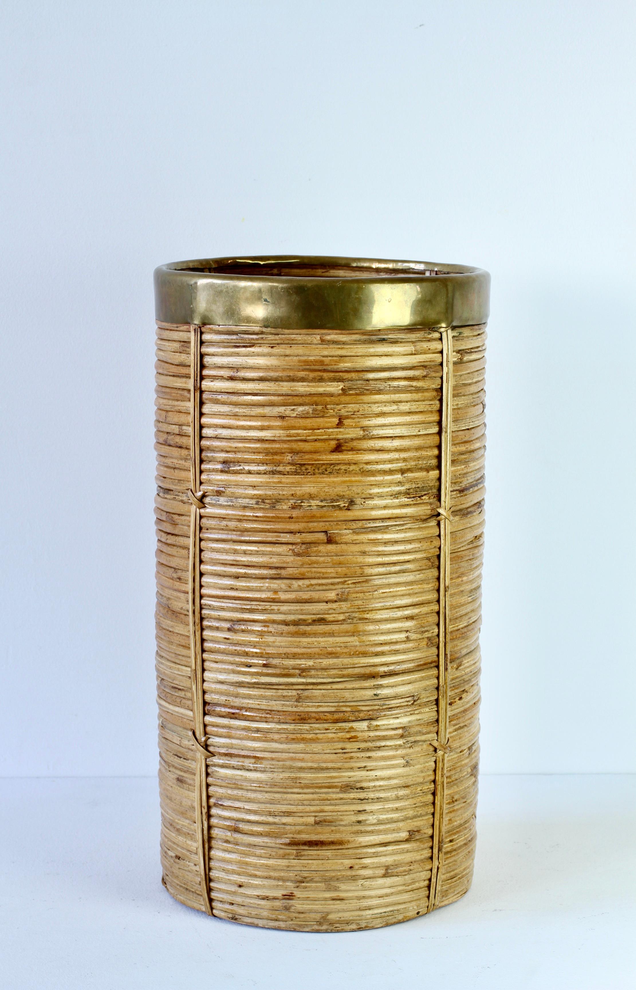 Tall and large midcentury Hollywood Regency umbrella stand / holder made in Italy, circa 1970s. Made of bamboo and rattan with a patinated brass metal rim, which finishes the piece perfectly. A must have for any Hollywood Regency enthusiast and