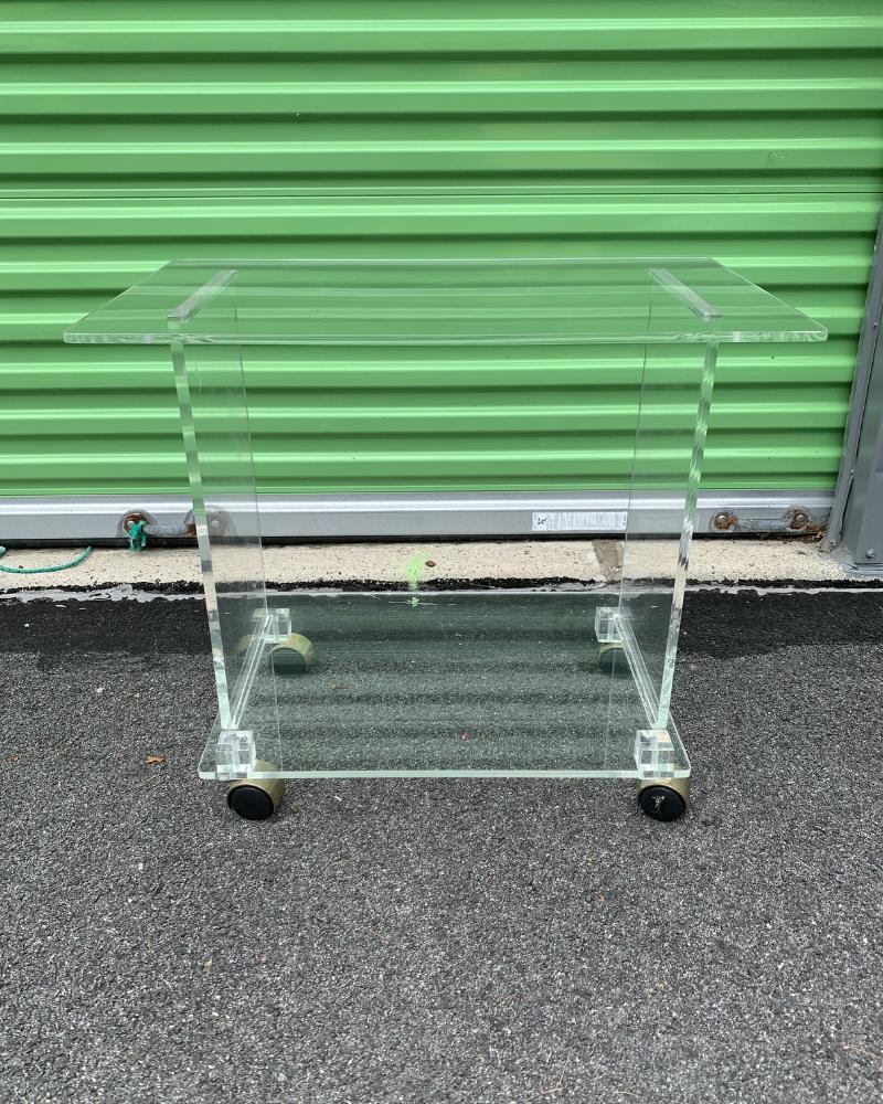 1970s Vintage Mid-Century Modern Lucite TV or Bar Cart

This vintage lucite cart is a must-have for anyone looking to add a touch of retro style and functionality to their home. The unique design and high-quality materials make it a valuable and