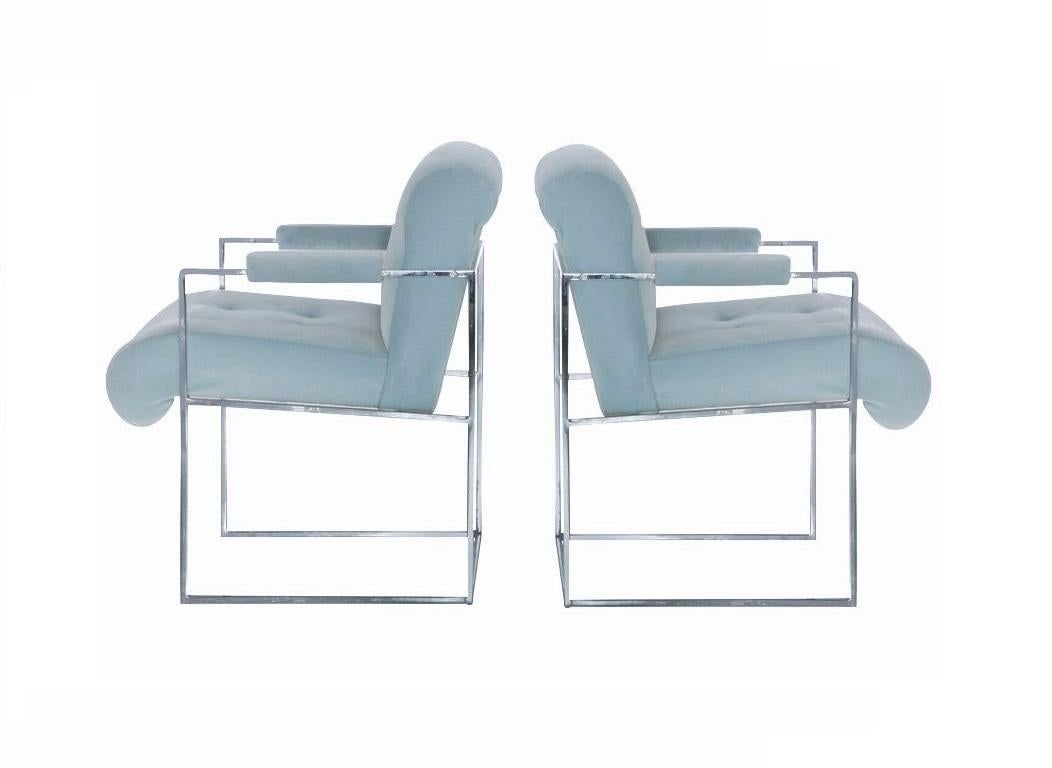 Set of two Milo Baughman thin line dining or side chairs designed for Thayer Coggin. These elegant armchairs feature slender gleaming chrome frames with super comfortable undulating seats with rolled backs and padded armrests. The frames