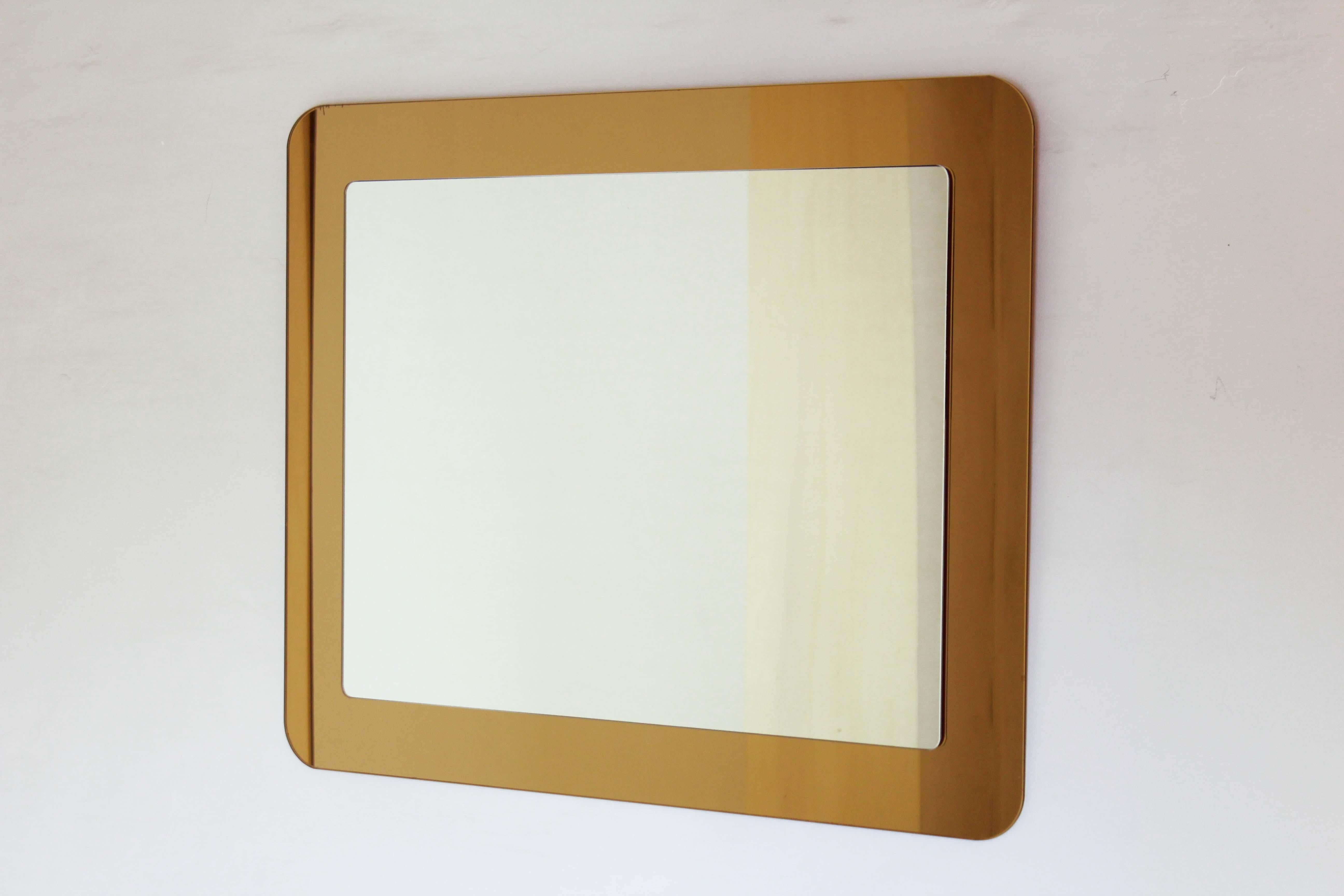 A 1970s vintage wall mirror. Double colour glass (gold and silver). In very good conditions.