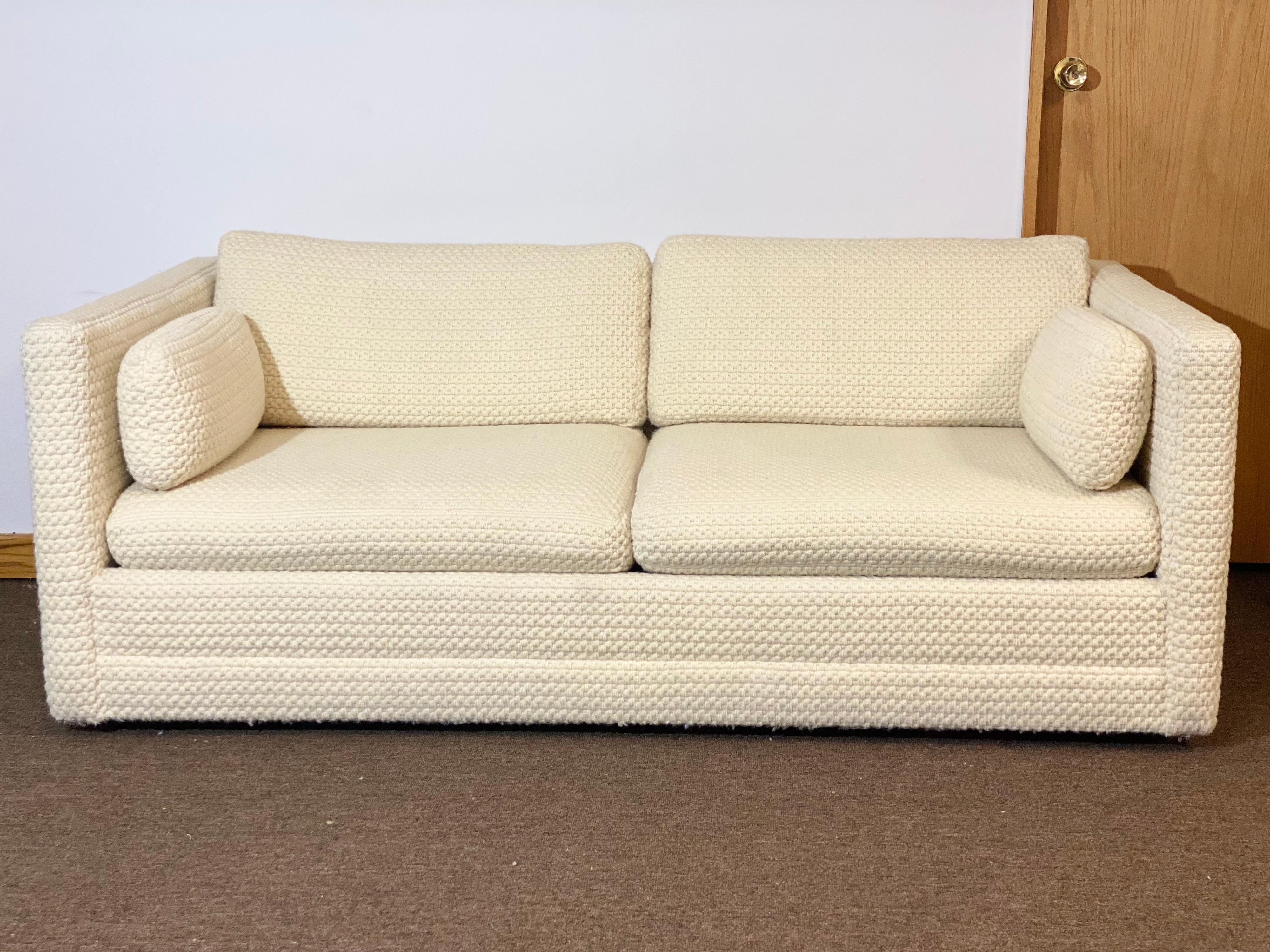 We are very pleased to offer a chic sleeper sofa circa the 1970s. This piece showcases a clean modern silhouette, its back and side pillows and overall enveloping frame is the perfect piece to curl up for movie nights or reading a good book.