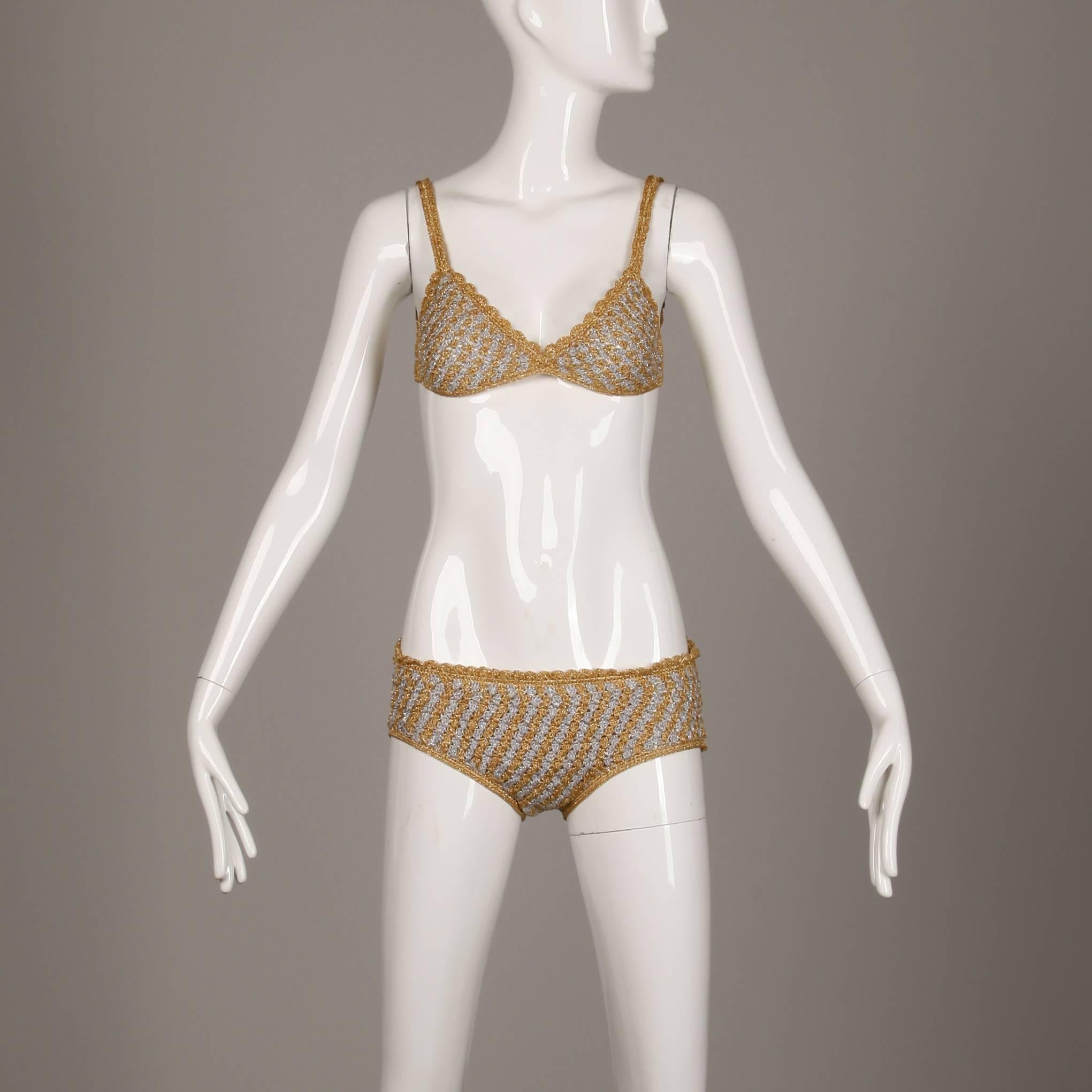 Bottom Lined
Top Unlined
Top Back Rings Closure
Marked Size: 12
Estimated Size: XS
Color: Gold/ Silver
Fabric: Metallic Yarn Crochet
Label: Moggie

Measurements: 

Bust: 32