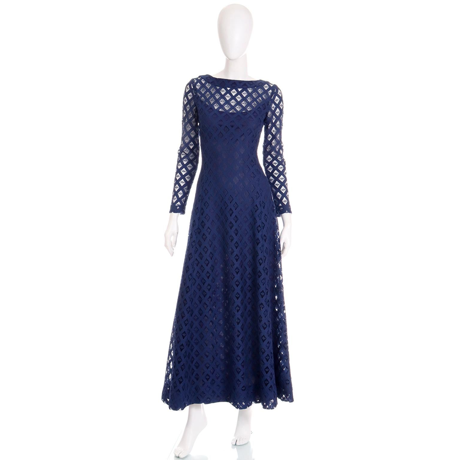 We love this vintage navy blue dress with its cutwork overlay. This pretty cotton dress could be worn during the day or during the evening depending on the accessories chosen to wear with the dress.  The sleeves and upper bodice are sheer and there