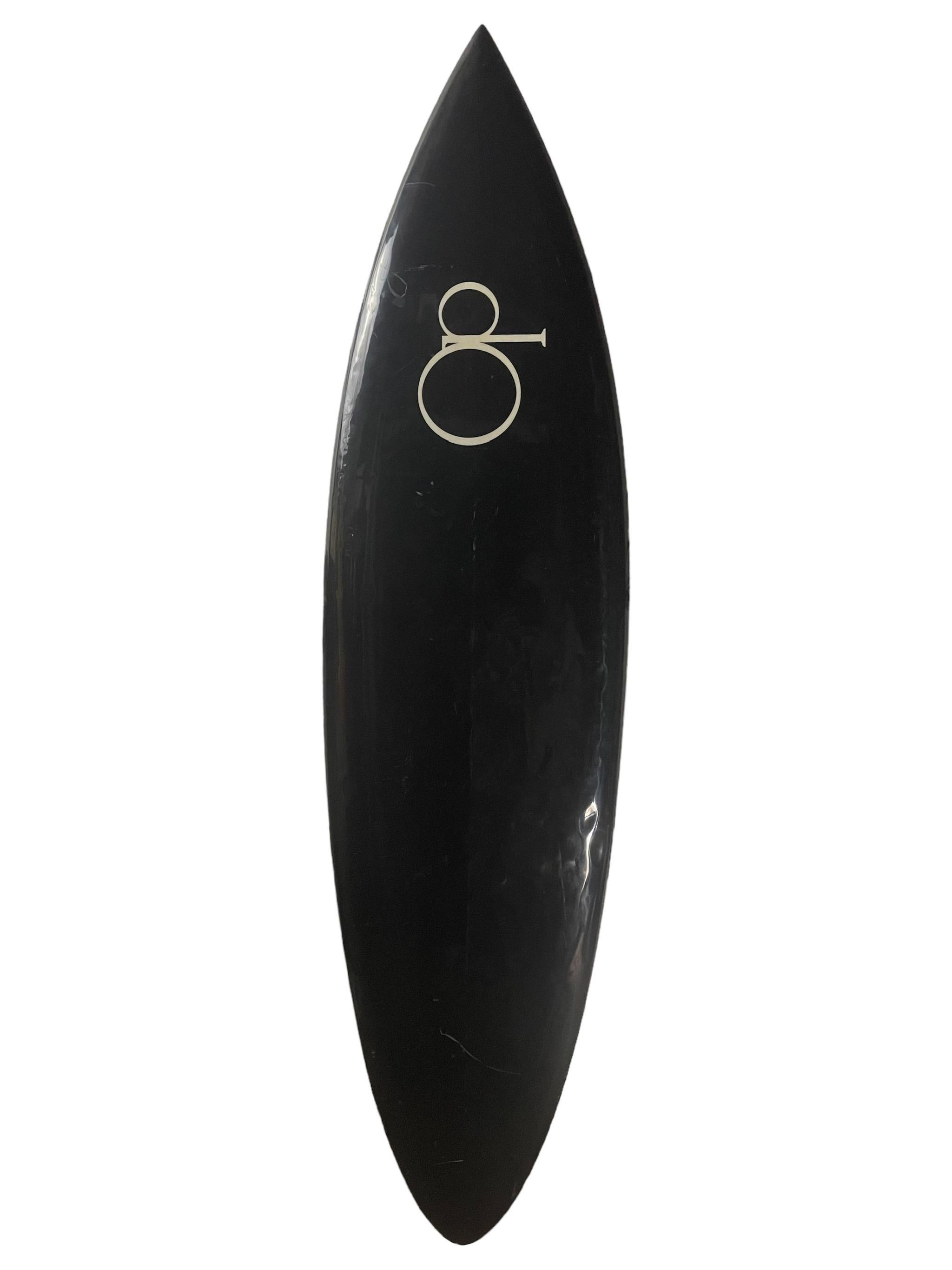 Vintage 1970s Ocean Pacific dolphin mural artwork surfboard. Features sleek black tint with breathtaking airbrushed mural depicting dolphins breaching the water. Round pintail shape design. A remarkable example of an original 1970s vintage surfboard