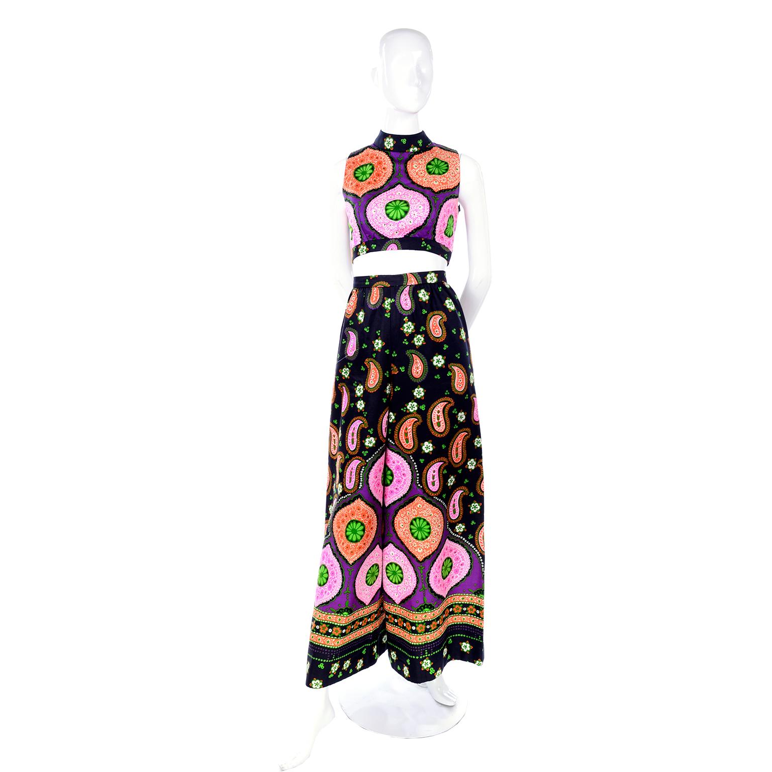 This is such a great 2 piece outfit that would be perfect for any  summer party and is the perfect day dress alternative! The ensemble has a crop top and wide leg pants in black cotton with an orange, pink and green paisley and floral print. The top