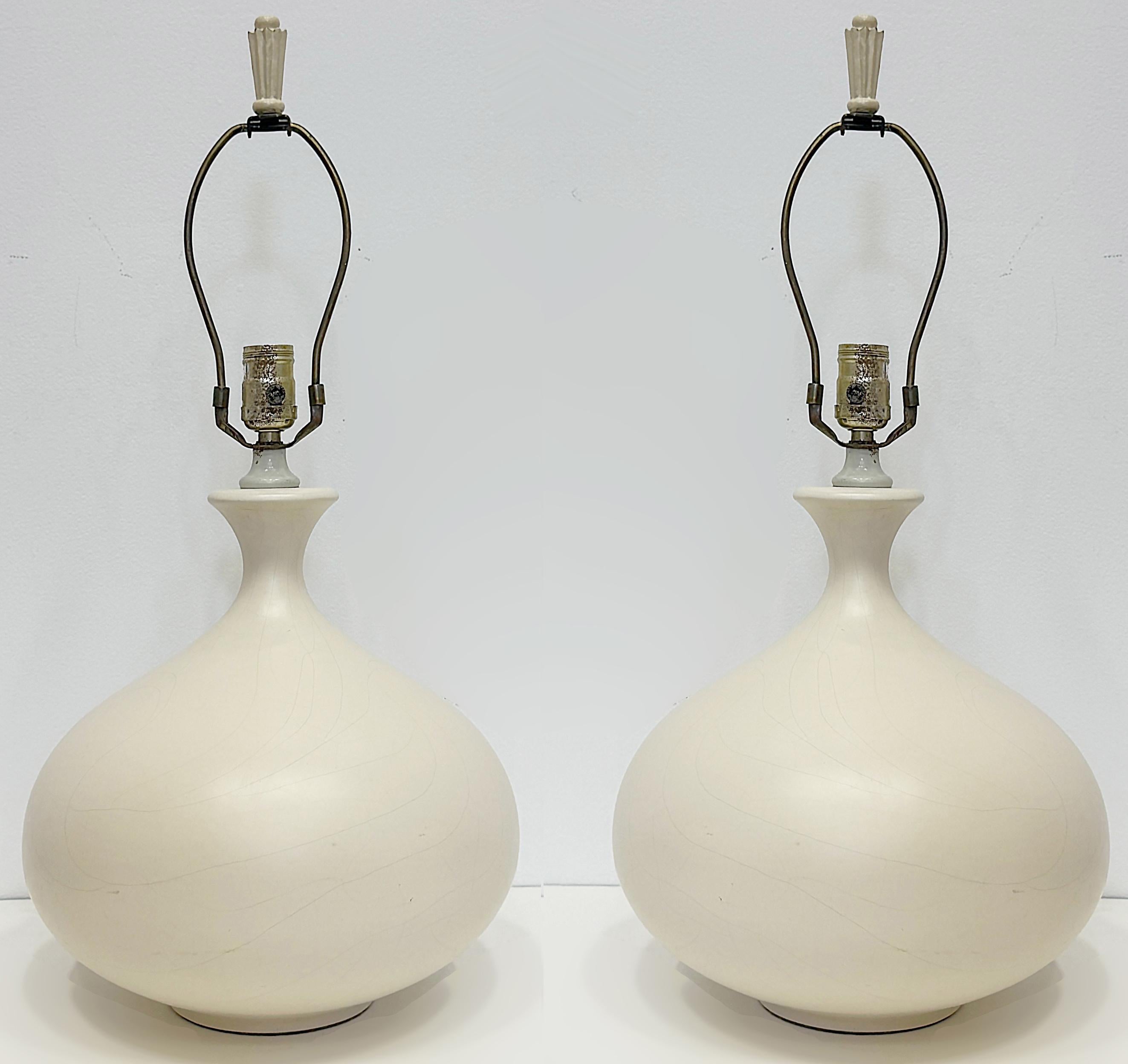 1970s Vintage Pottery Lamps, Manner of Jacques Grange, Pair

Offered for sale is a pair of 70s vintage pottery lamps in the manner of Jacques Grange. The bulbous form tapers in up to the top where a single socket with a harp is included. The