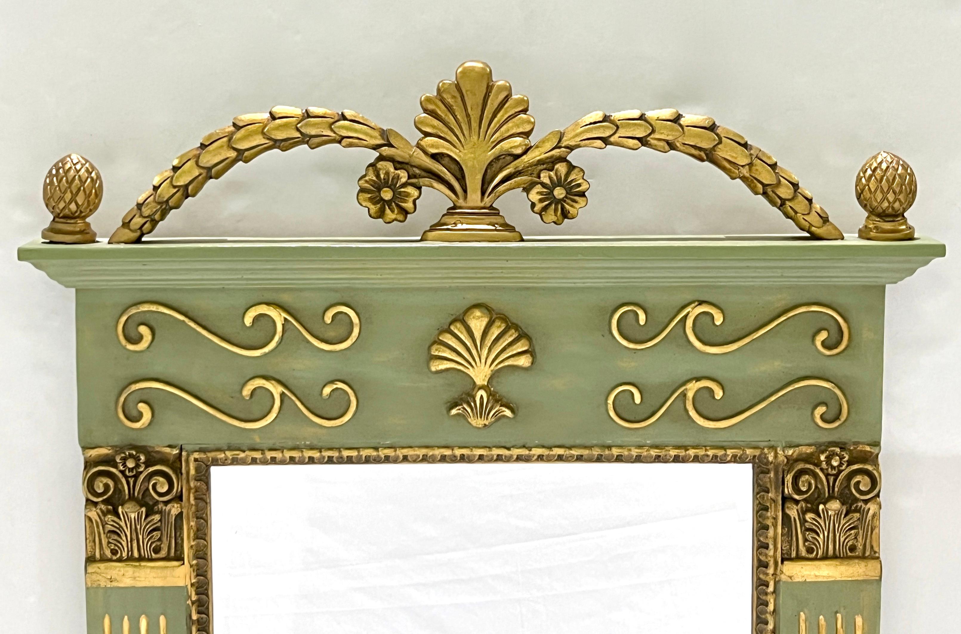 A mid-20th century modern French decorative painted wood trumeau mirror, in an Empire revival design, decorated in a Napoleon apple moss green painted color, with extensive gold accents and decorative carvings: fluted sides, a nicely beveled mirror