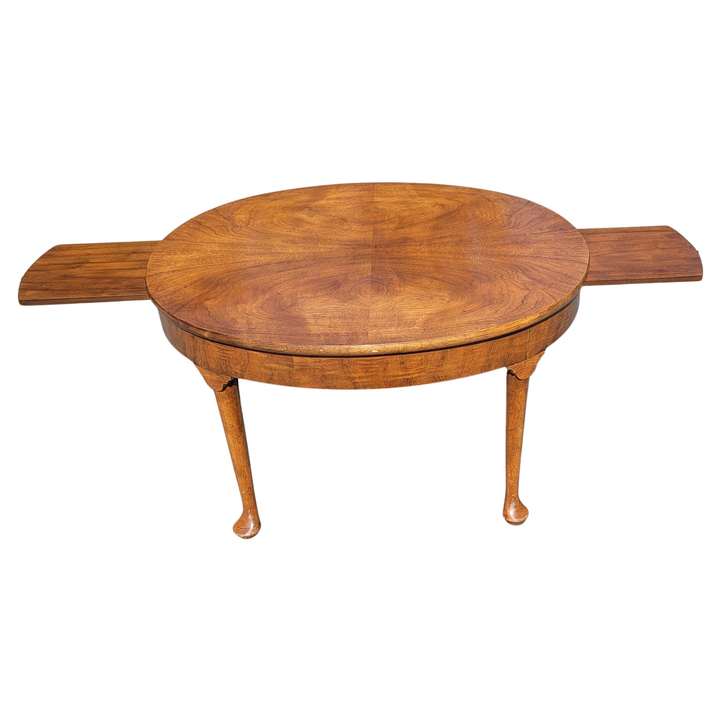 A beautiful 1970s Vintage Queen Anne style walnut oval extension coffee table with 2 pull-out trays. Pull out extension trays are 10 inches, for a potential maximum table width of 56