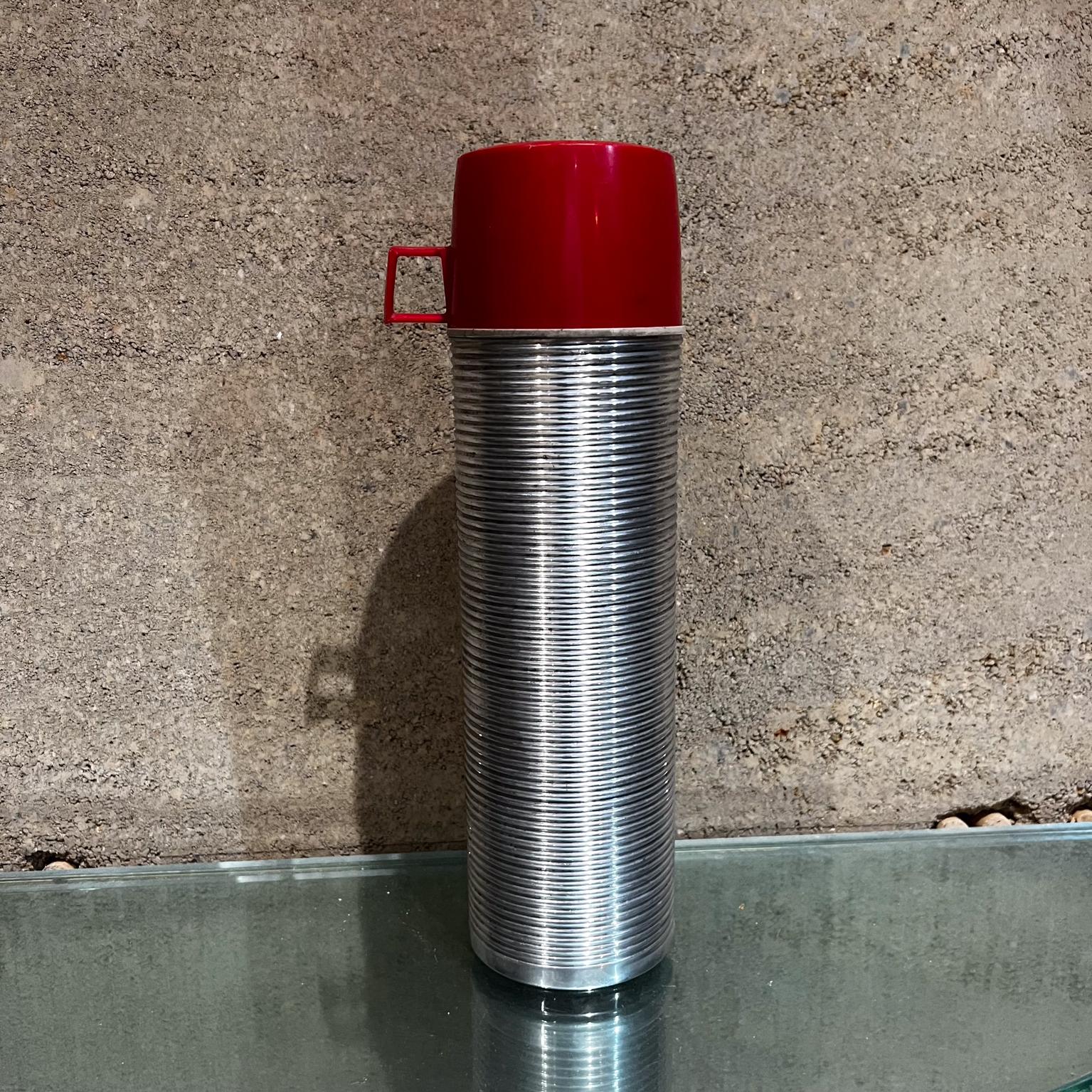 1970s Vintage Ribbed Thermos Retro Camp Gear USA
Quart size thermos with red cup. 
Insulated.
13.25 tall x 3.75 diameter Cup 2.5 tall x 3.75 diameter x 4.75 d
Original vintage condition. See all images.
