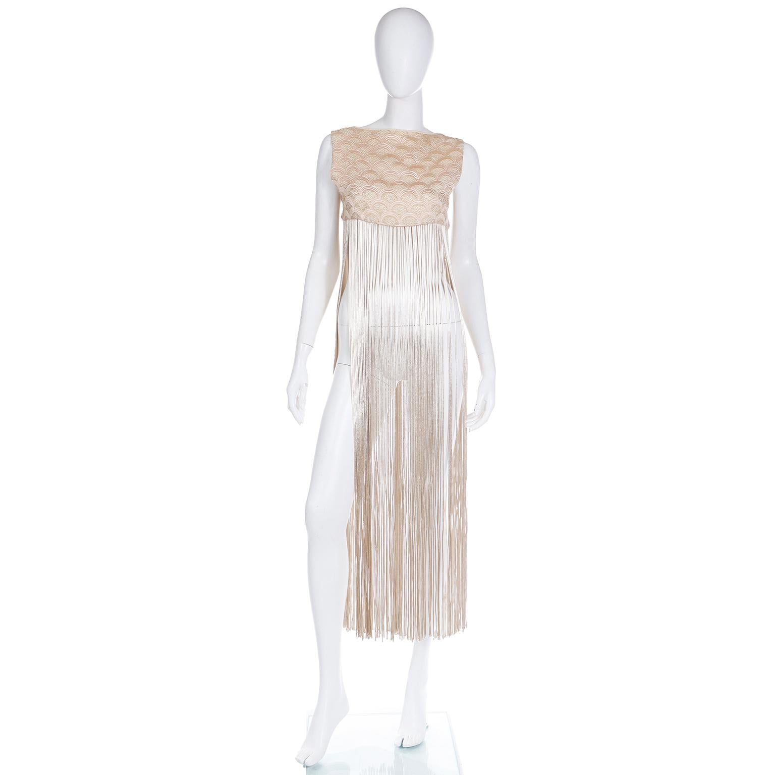 This great vintage 1970's long fringed vest is so gorgeous and it would add the perfect amount of drama and style to so many things you already own! There is detailed fish scale embroidery on the bodice in a soft pink set apart with gold metallic