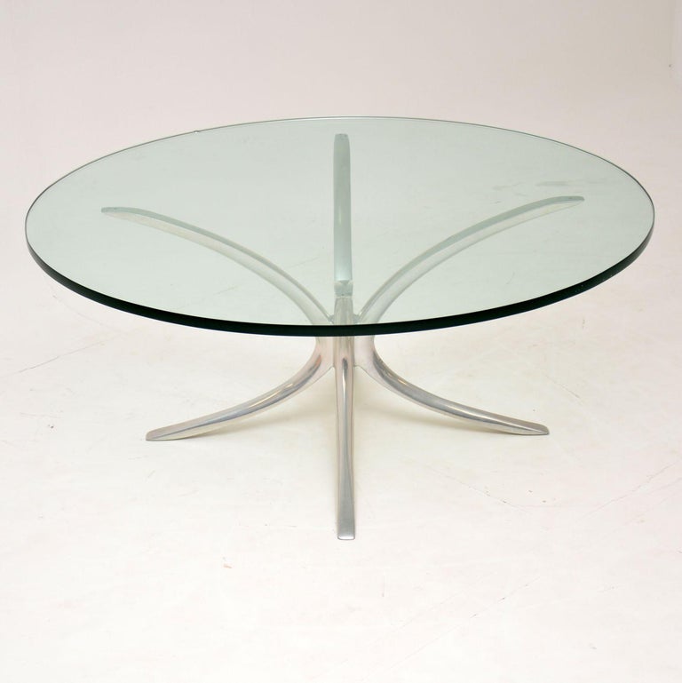 A stunning vintage coffee table dating from circa 1970s. This has a beautiful solid brushed steel spider shaped base. The glass top that sits on the base is extremely thick and heavy, this table is superb quality throughout. The base just has some