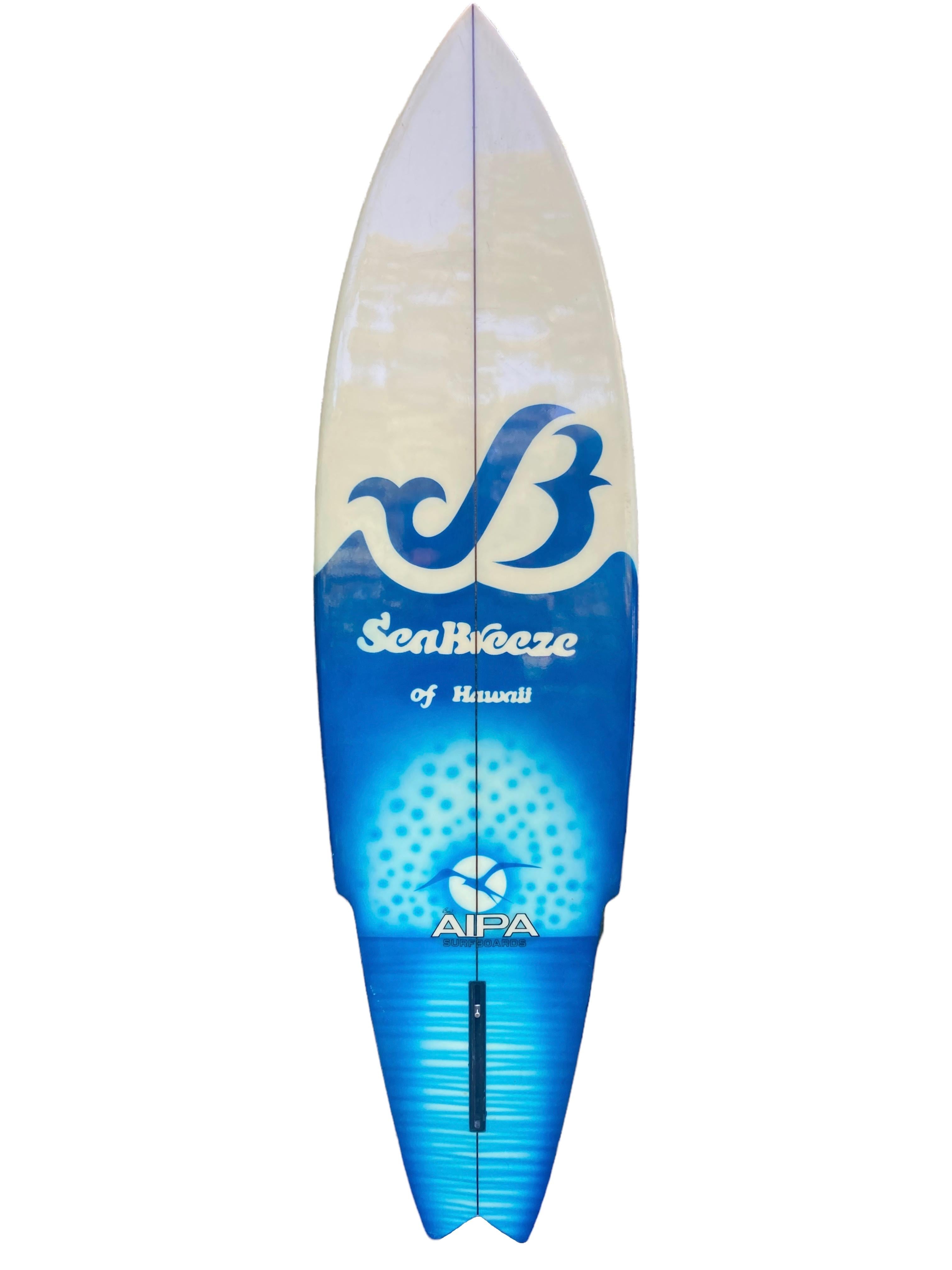 Early-1970s AIPA Surfline-Hawaii sting surfboard shaped by the late Ben Aipa (1942-2021). Features the renowned Sting surfboard shape design with gorgeous “Sea Breeze of Hawaii” airbrush artwork. An astoundingly well preserved example of an early