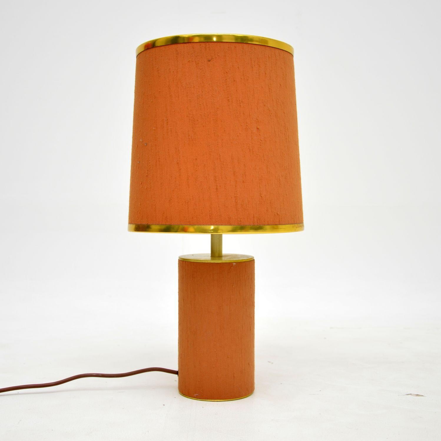 A lovely vintage table lamp in brass, wrapped in peach fabric. This was made in England, it dates from the 1970s.

It is of excellent quality and this has quite an unusual design. It is a lovely size, and would be useful in various positions
