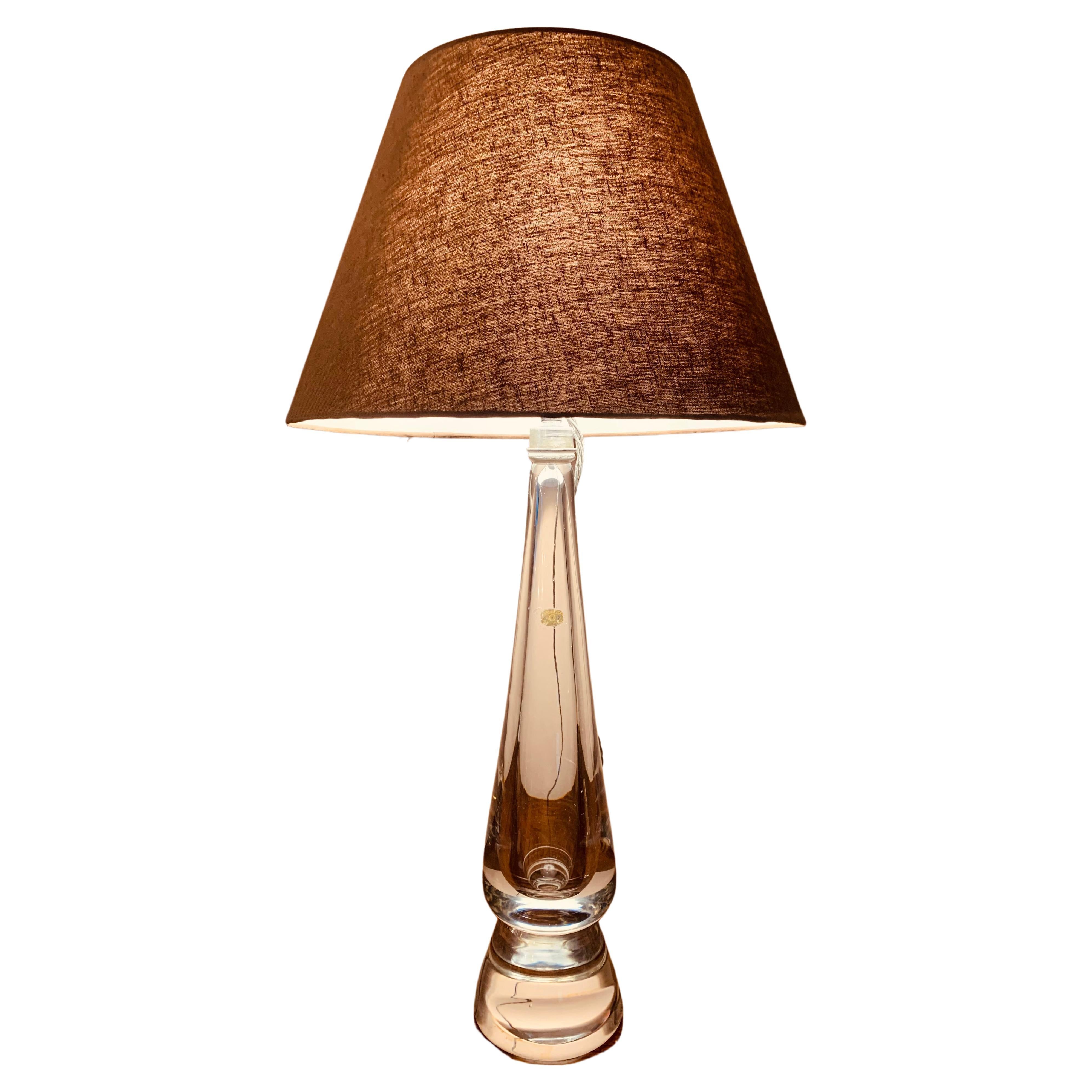 A large clear glass Belgium table lamp.  The conical base section is made from solid glass and is very heavy.  A small Val Saint Lambert original foil label has been sellotaped onto it, upside down, but having researched this design and from my own