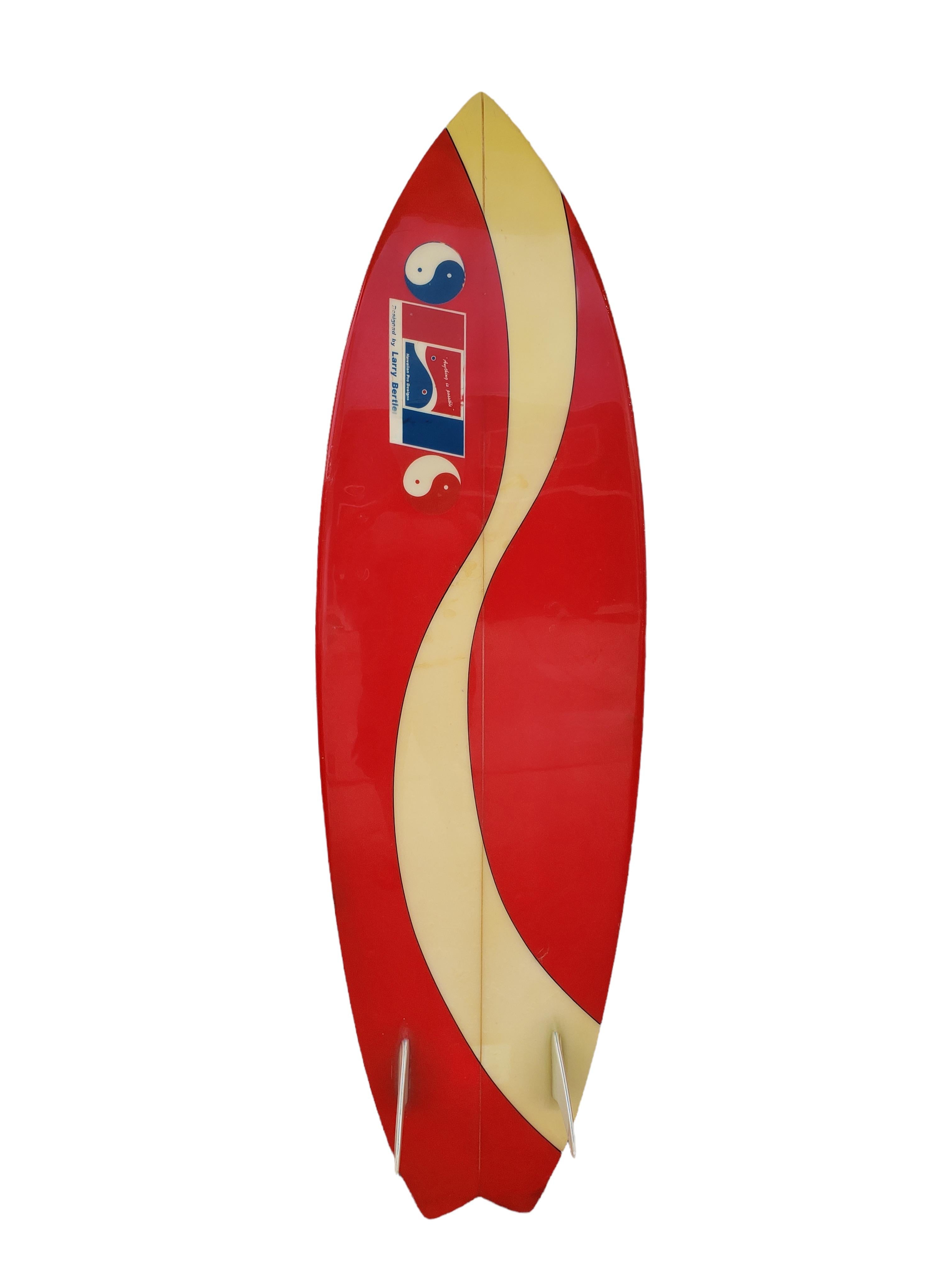 Vintage 1970s Town and Country twin fin shortboard hand shaped by Larry Bertlemann. Features a gorgeous red tint with classic swirl pattern and unique pinstriping on the twin fins. Hand signed “LB” on the foam which indicates this board was hand