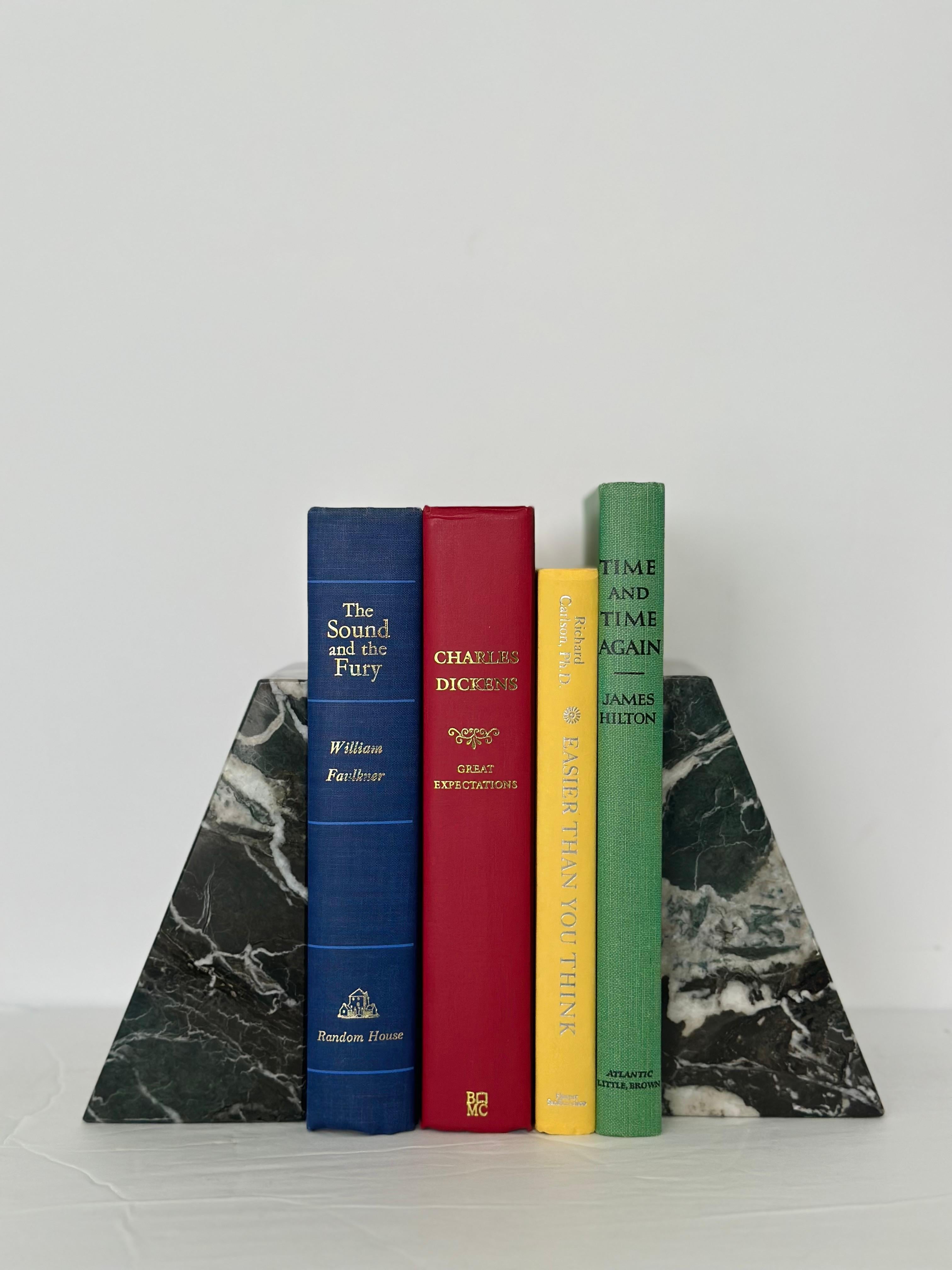 We are very pleased to offer a vintage, sleek, pair of polished stone bookends, circa the 1970s.  This set is constructed of solid, heavy-weight marble and skillfully hand-cut and hand-polished.  Each bookend showcases dark green and black tones and