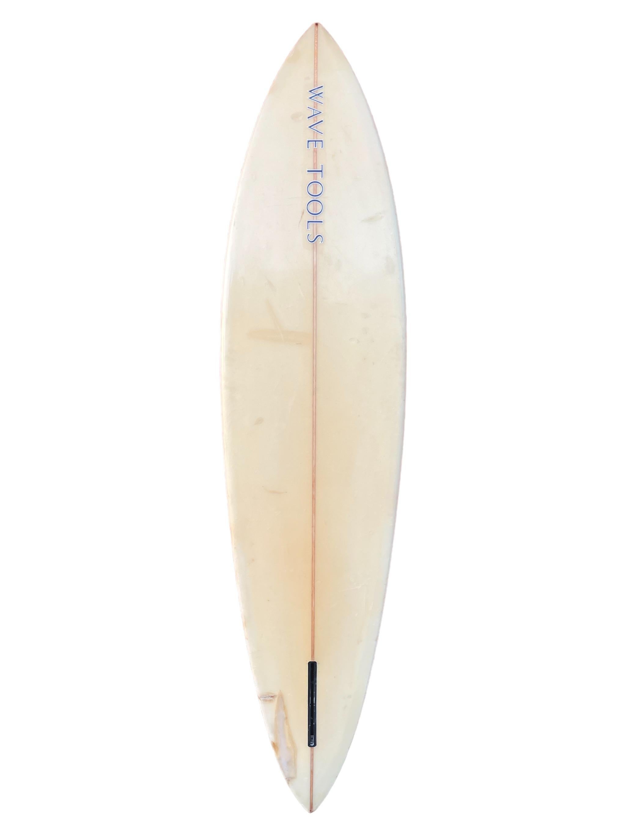 Late-1970s Wave Tools surfboard made by Lance Collins. Features sea-foam blue tinted deck with pinstriping. Pintail shape design. Signed by Lance Collins. A great example of an original 1970s vintage Wave Tools surfboard. 