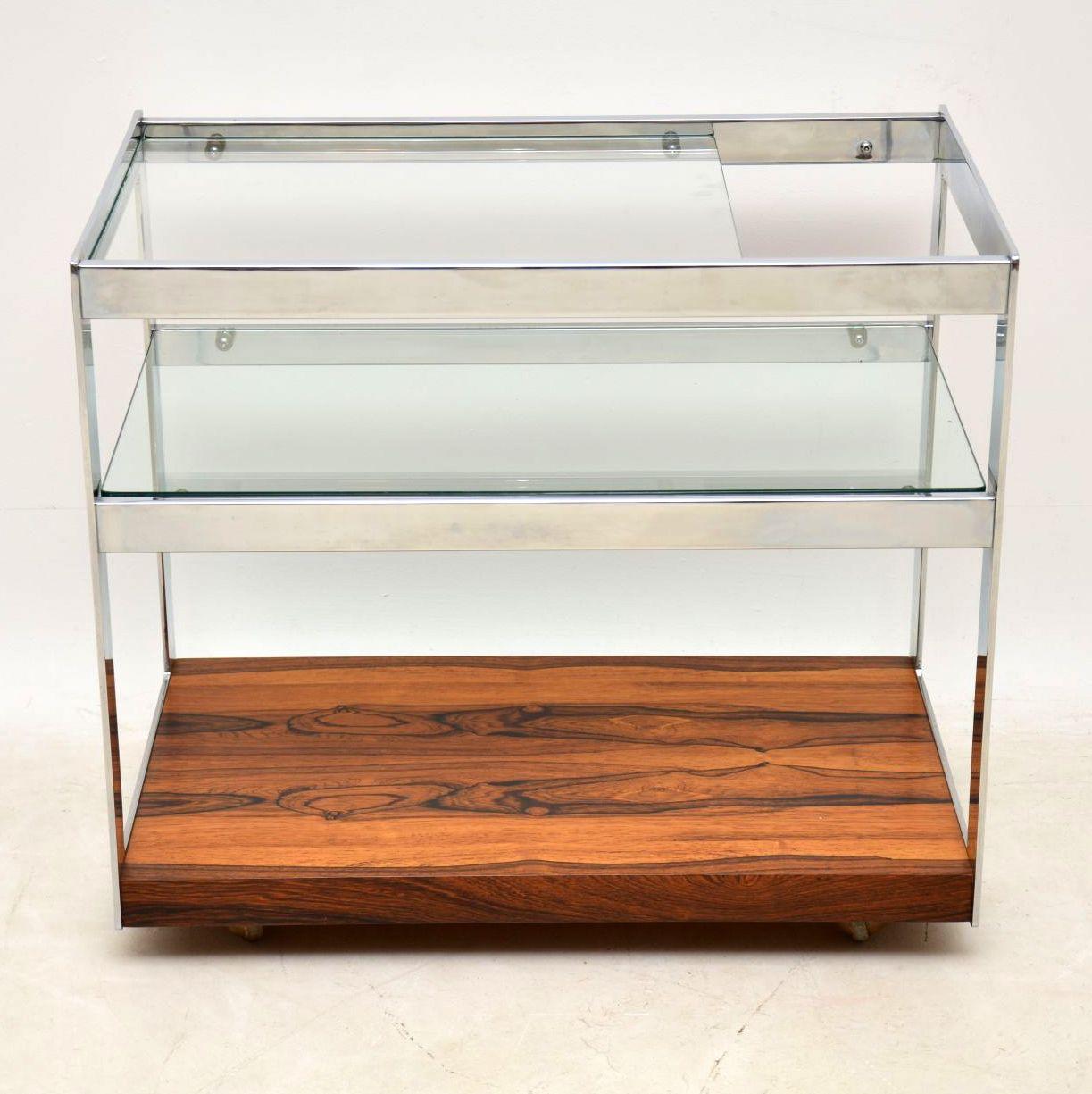 A stunning vintage drinks trolley from the 1970s, this was designed by Richard Young for Merrow associates. It’s of superb quality, with a thick chrome frame and a beautiful wood base. The condition is superb for its age, with only some incredibly