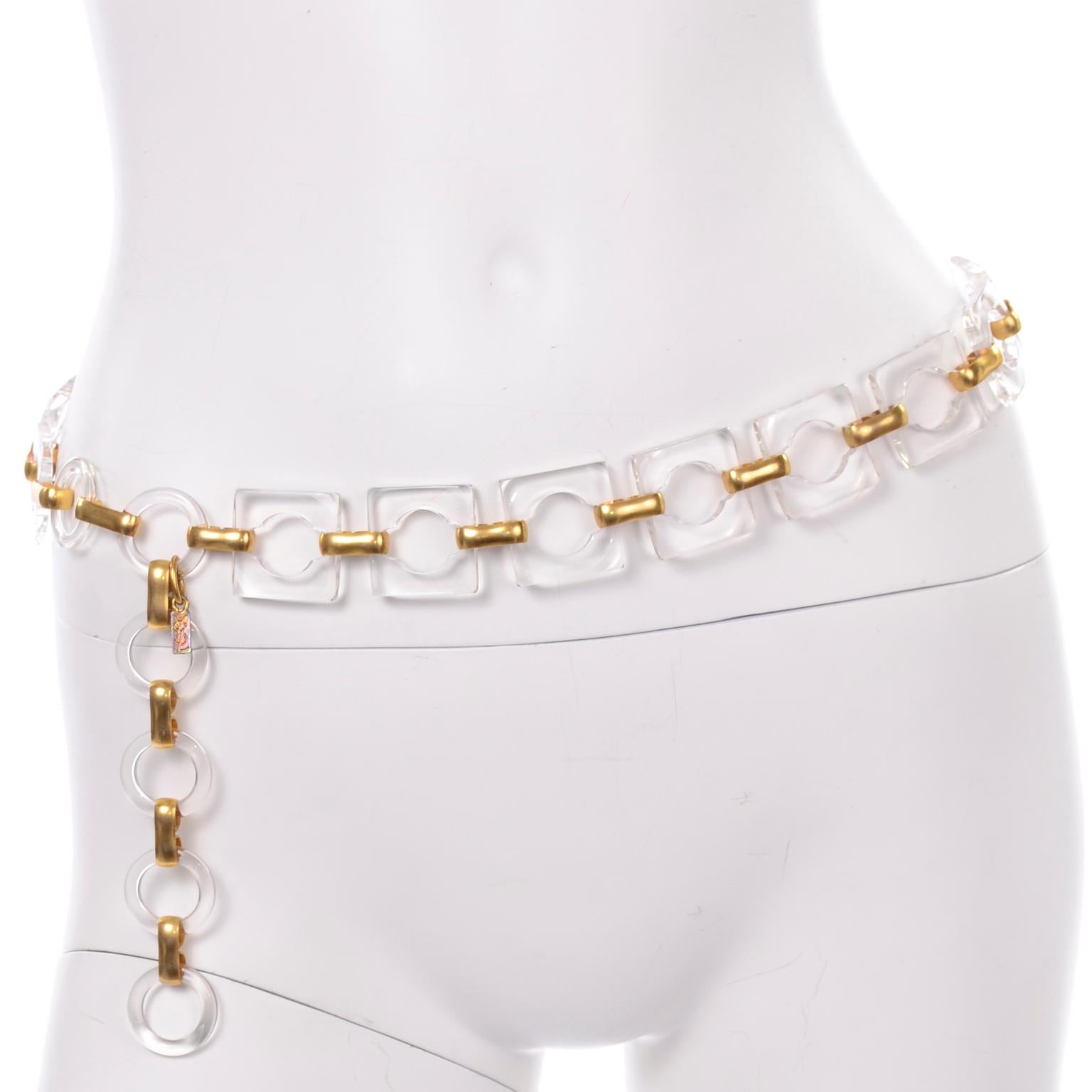 We love this vintage 1970's YSL square lucite link belt w/ gold metal hardware! The beautiful lucite squares and circle donut shapes are connected by beautiful gold hardware hooks. This is completely adjustable with extra lucite loops that gives it