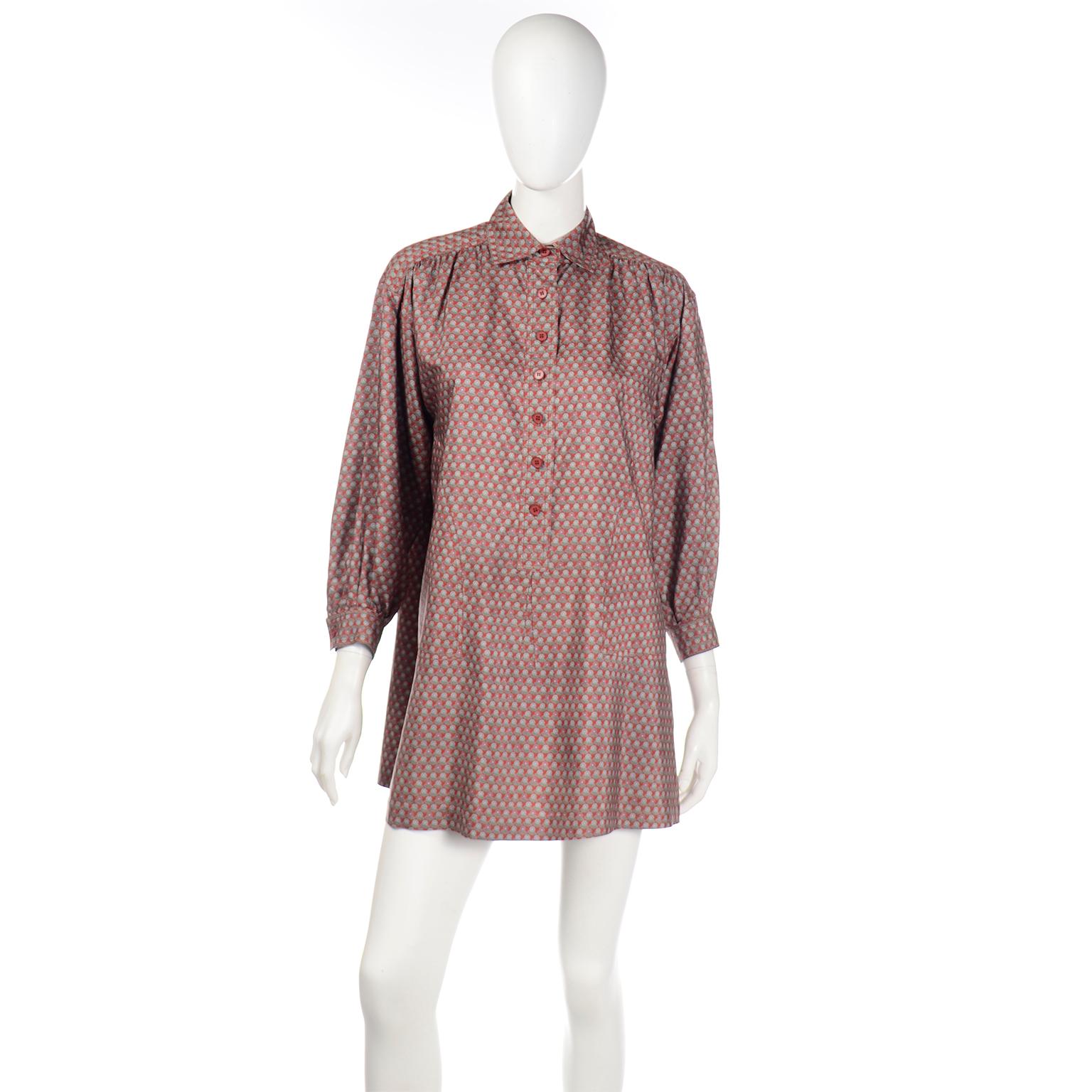 This vintage 1970's Yves Saint Laurent peasant style tunic top or mini dress has a beautiful brick red base color with faintly printed flowers throughout the fabric. The proximity of the flowers creates a slightly abstract appearance from a