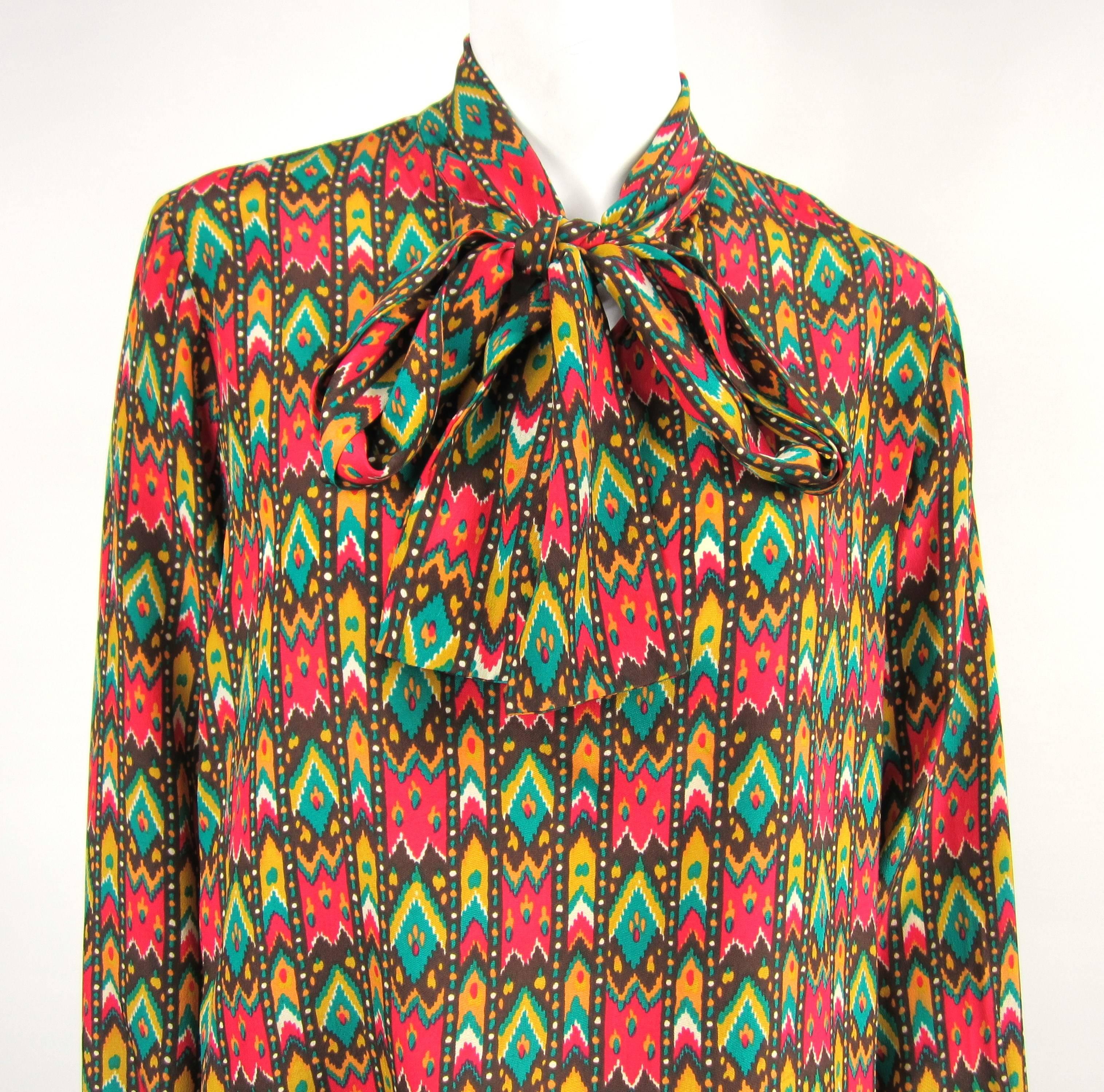 Has a bit of a southwestern vibe! YSL silk 1970s Blouse- Measuring Up to 40 Bust -- Up to 40 waist-- 25 long -- 23.5 sleeve, buttoned cuff. This is out of a massive collection of Contemporary designer clothing as well as Hopi, Zuni, Navajo,