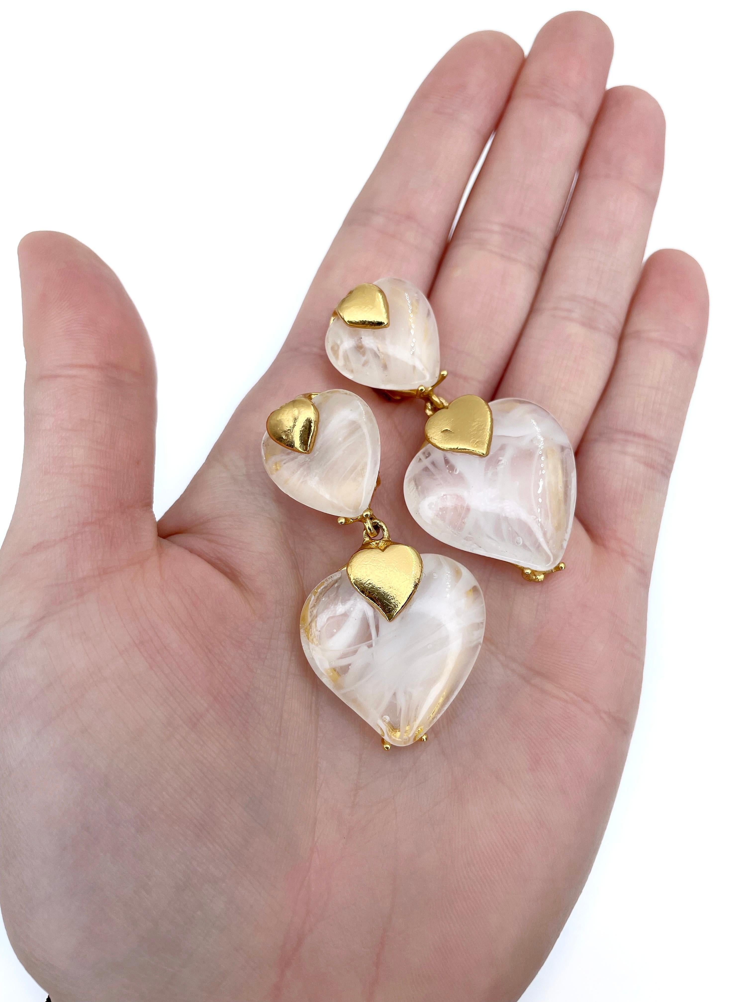 This is a gold tone vintage heart shape clip on earrings designed by YSL in 1970’s. This piece is gold plated. It features white transparent lucite.

Signed: 