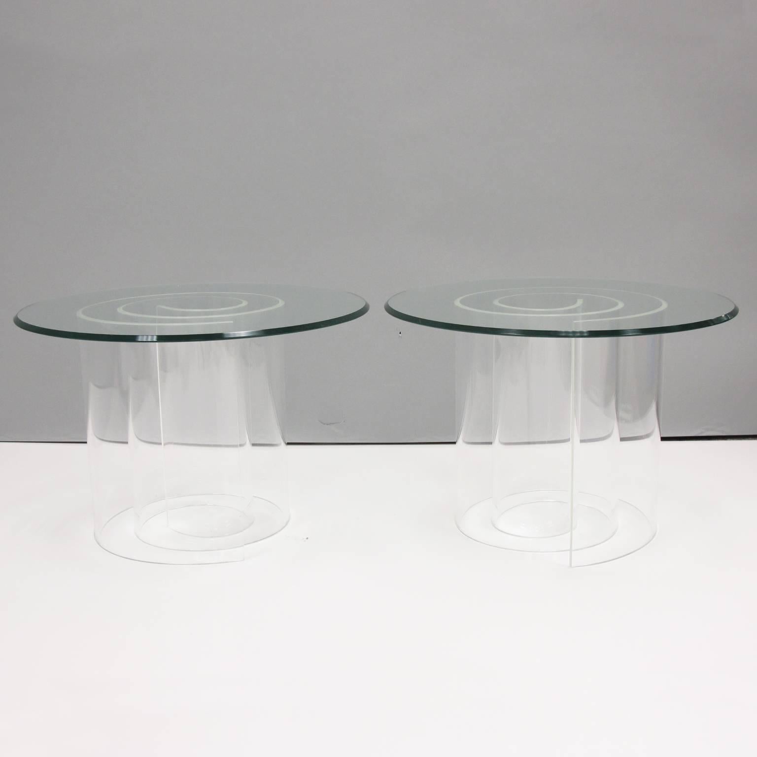Elegant pair of round coffee or side tables in the style of Vladimir Kagan famous snail table. Snail or spiral thick clear Lucite base with clear glass table top with beveling. Sold as a pair.
Please check our last picture for reference, we do have