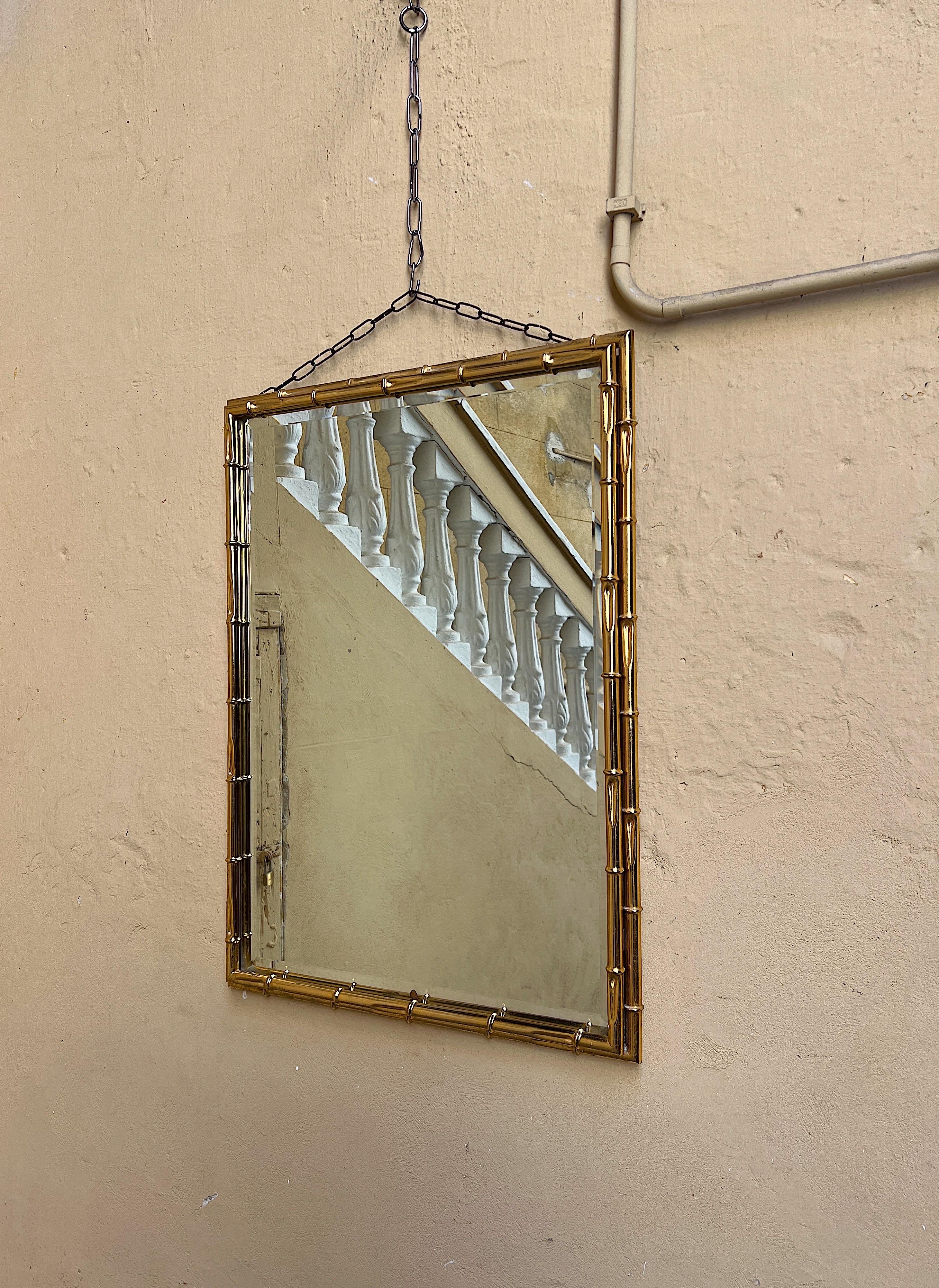 Italian 1970s wall mirror with a bamboo-effect gilded metal frame.  For Sale