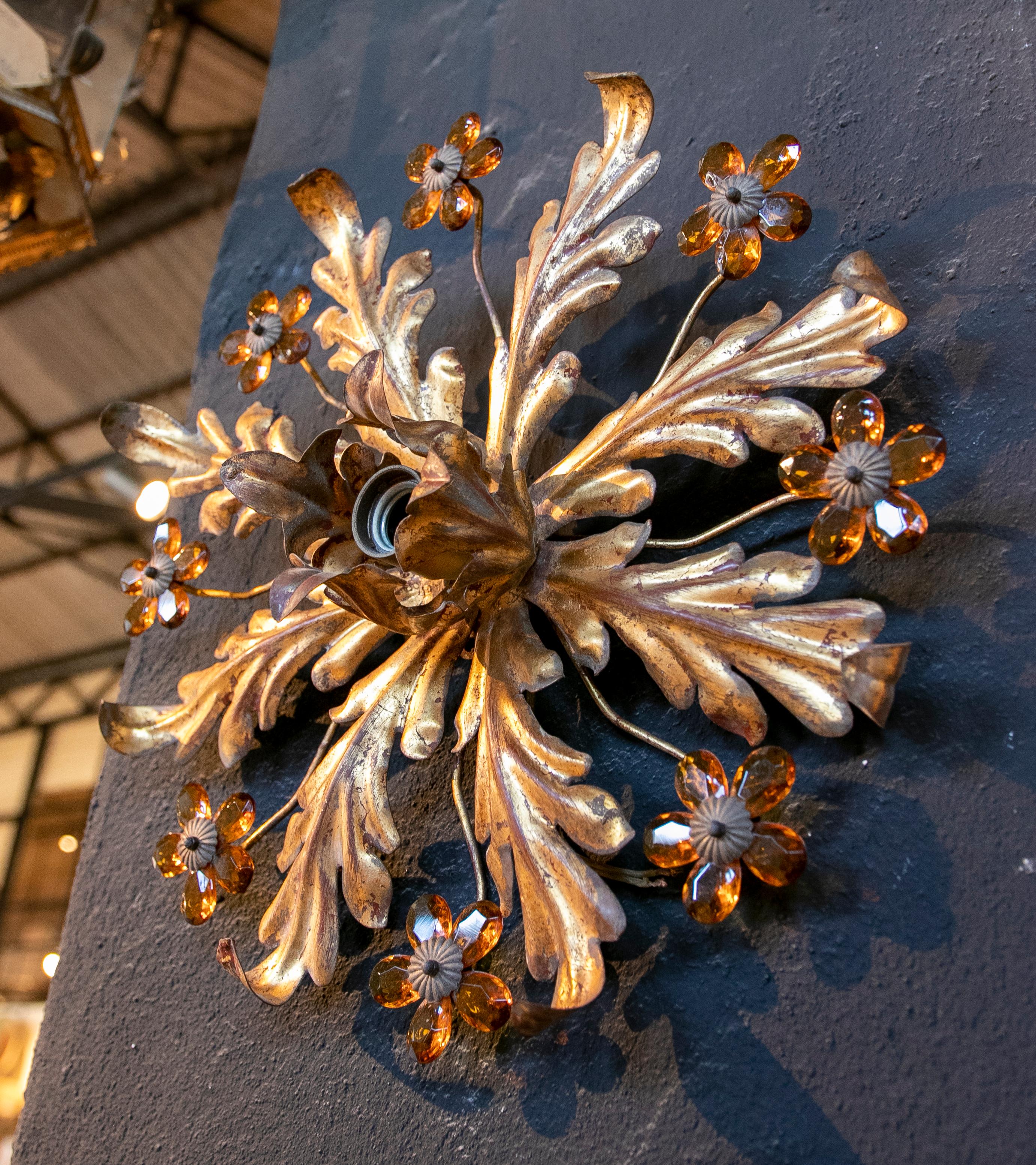 1970s Wall or ceiling lamp in gilded metal with flower decoration.