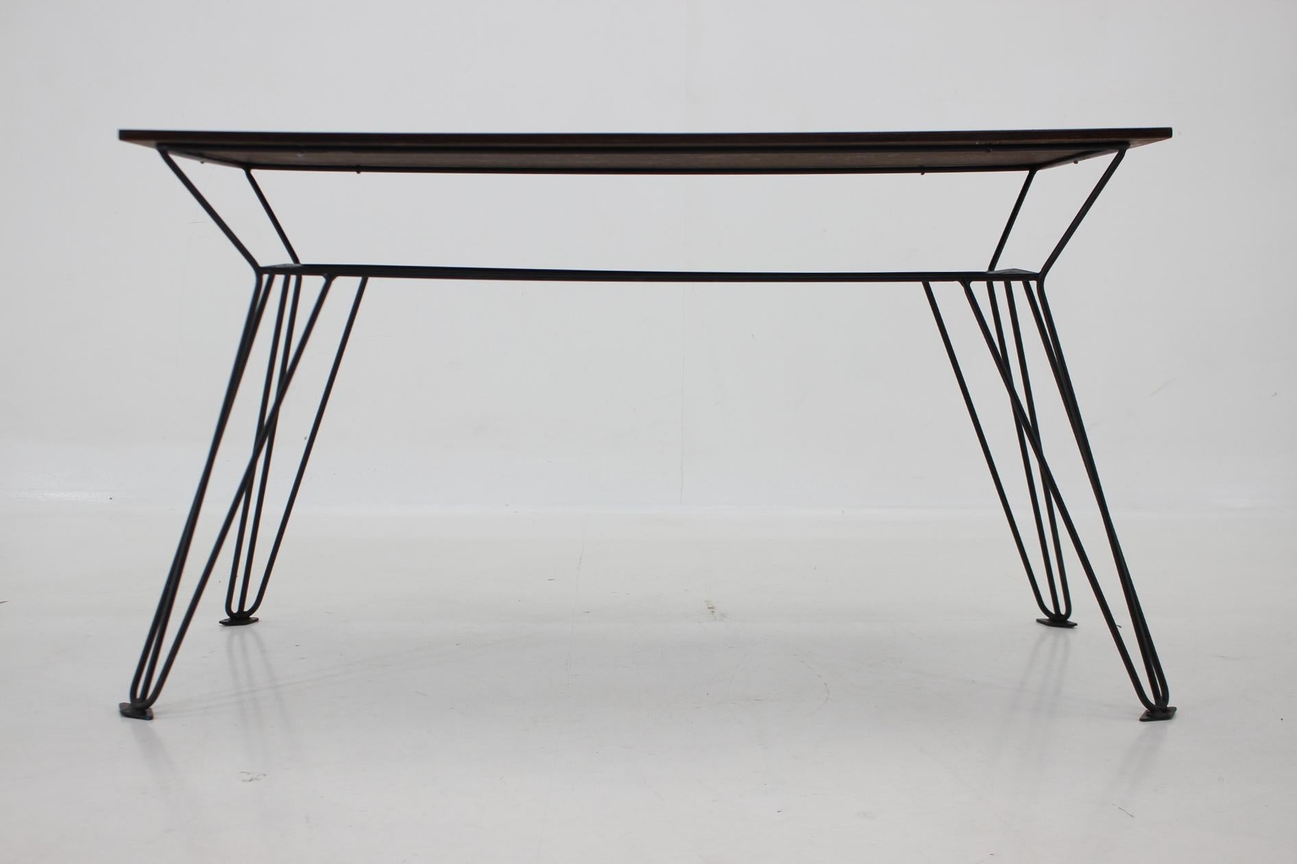 Vintage coffee or side table with wallnut veneer top and metal legs, produced in former Czechoslovakia in the 1970's.
