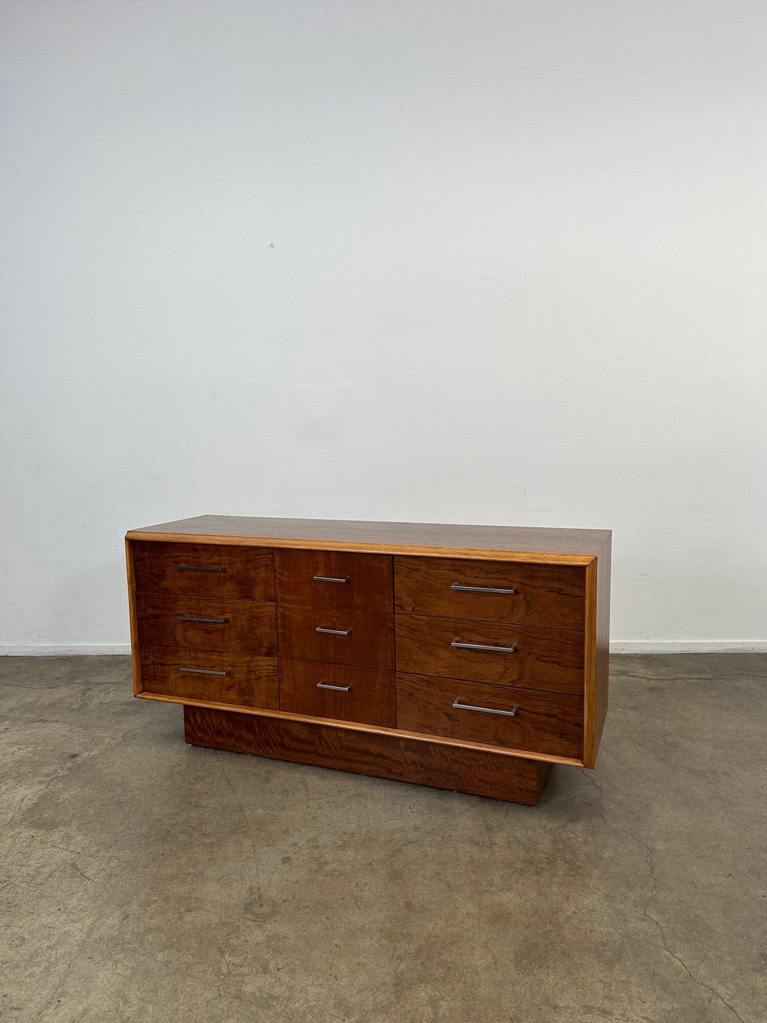 W58 D18 H28.5

Petite dresser with three large drawers and three smaller drawers on the side. This dresser features clean chrome hardware with dove tail drawers. The walnut plinth base is recessed and give the piece a brutalist style. This piece has