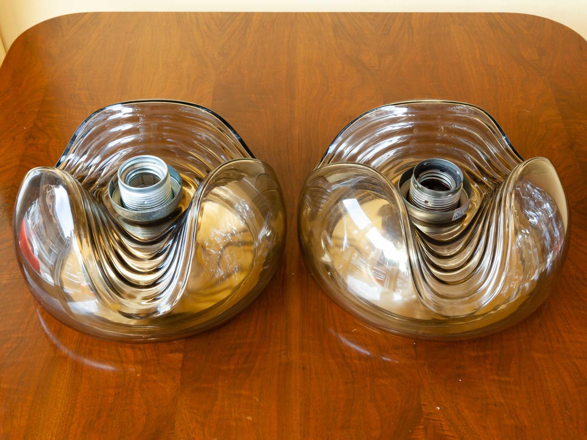 1970s 'Wave' smoked colored glass with a gold reflective base plate flush mount wall lights or sconces or ceiling mount lights designed by Koch and Lowy for Peill & Putzler Germany. A very Space Age futuristic look.

Sold as a pair available but