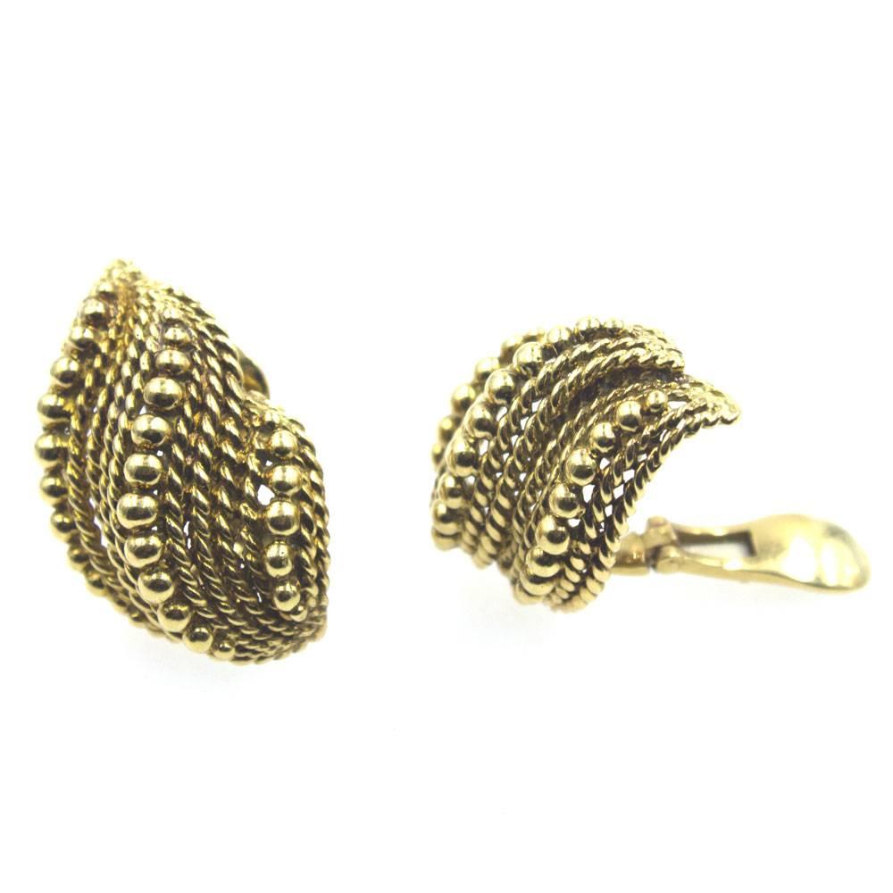 1970's Webb clip earrings fashioned in textured 18 karat yellow gold. The earrings measure 22 x 35mm and are signed Webb 18k. 