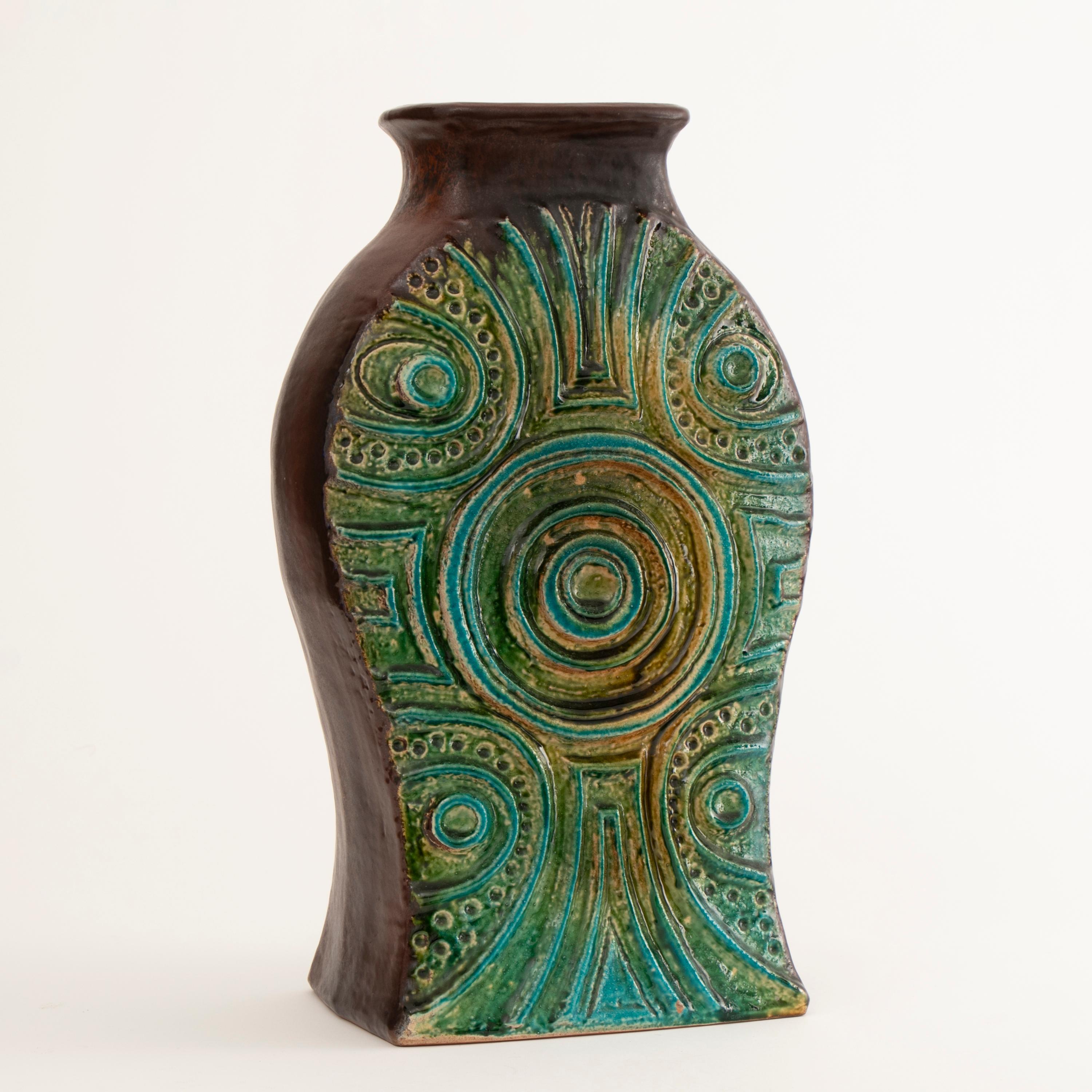 1970s West German pottery vase with a green, blue and yellow abstract glaze to the textured front and back framed with brown sides and neck by Carstens Tonnieshof. Model No 7850-50.

Measures: H 50cm, W 29cm, D 21cm.
