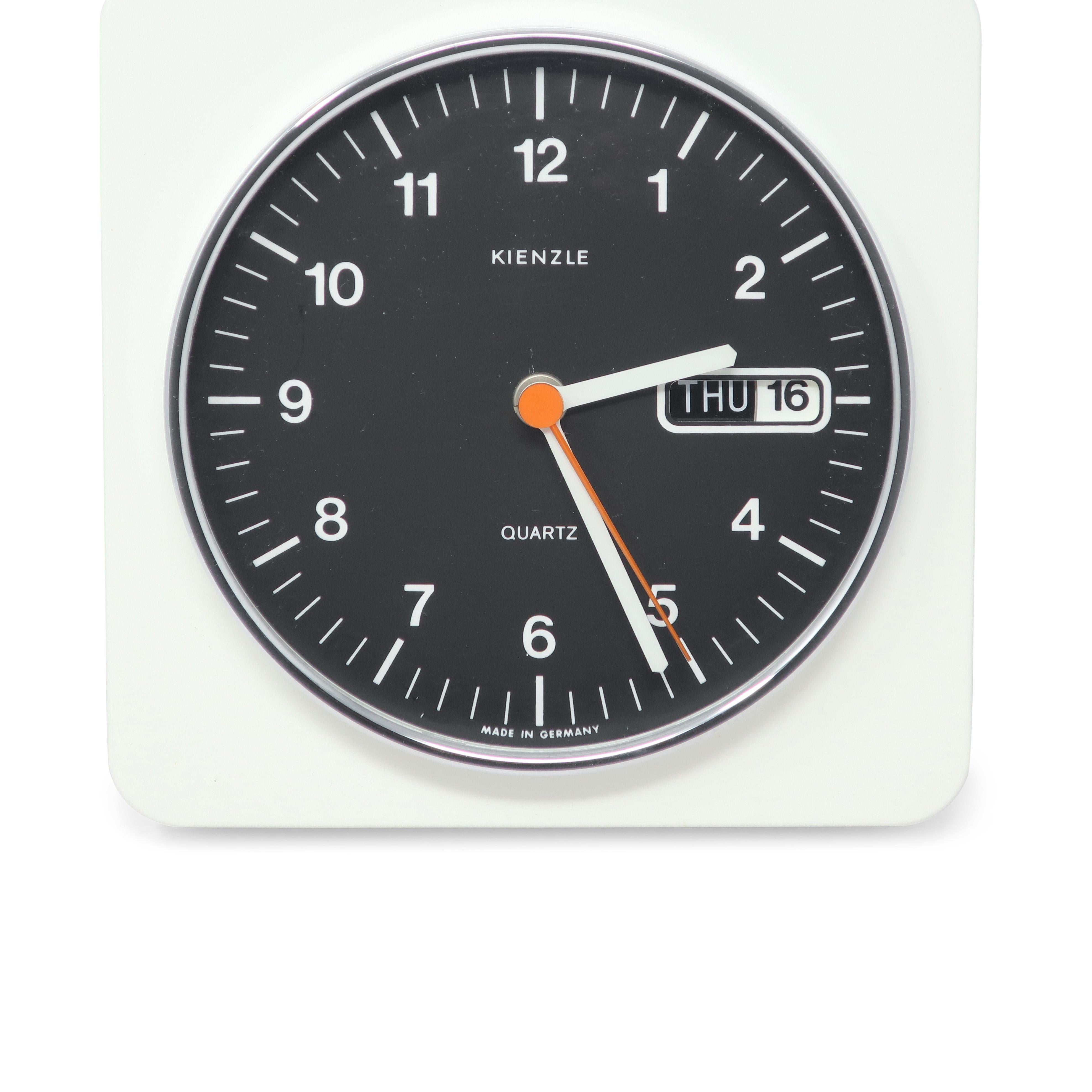 A vintage mid-century modern white, black, and chrome wall clock by German clock manufacturer Kienzle.  Body of this Space Age clock is white plastic, the face is black, and the numbers and hands are white, all of which provides a striking contrast