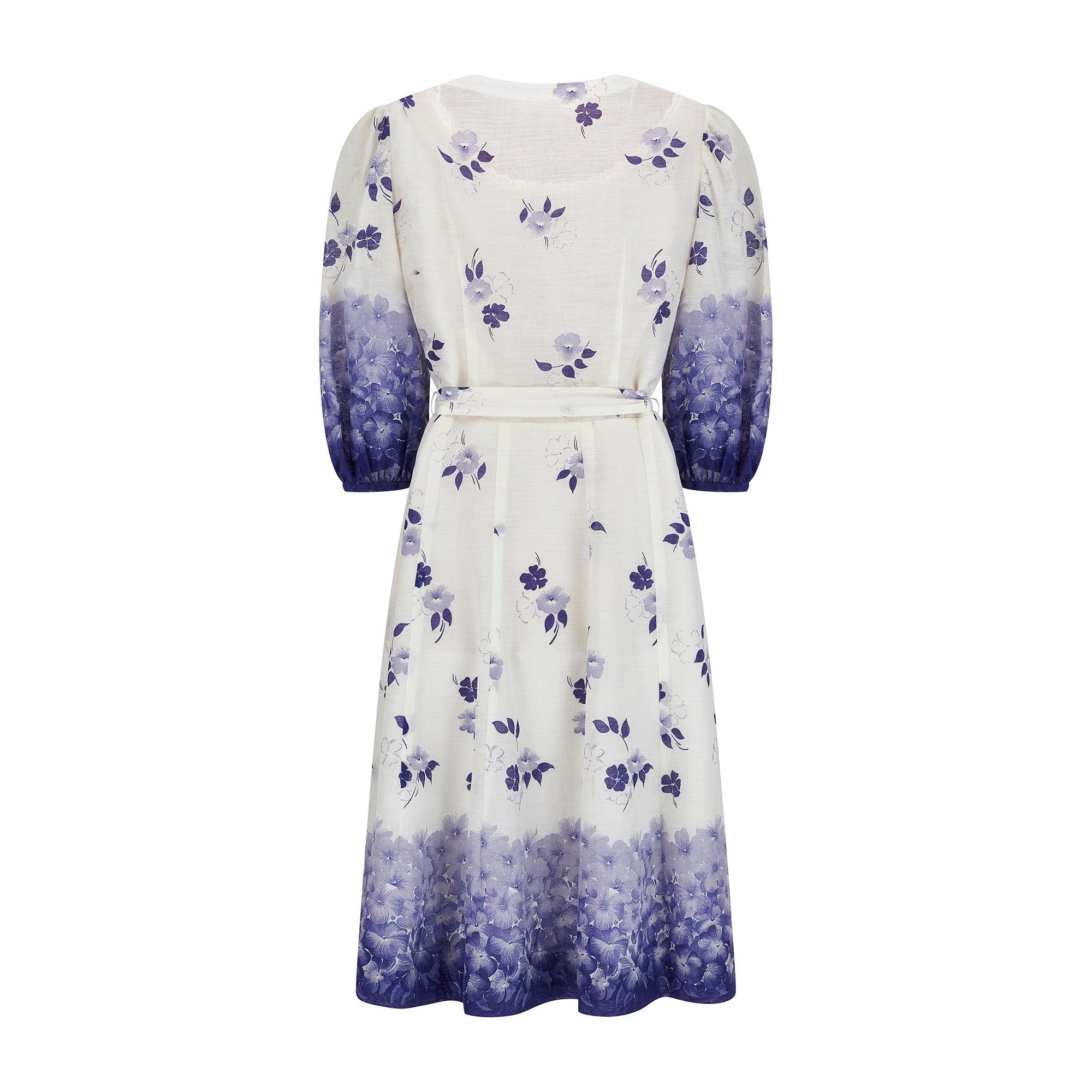 A very pretty French couture made 1970s dress, tailored from a mousseline (French for muslin) cotton. The notable print design is a delightful floral pattern in ombré purple-to-lilac against a white background. The dress has a sweetheart neckline