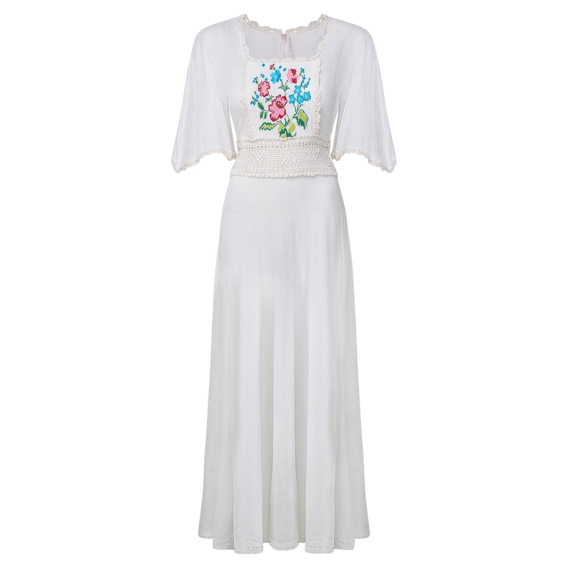 1970s White Cheesecloth and Crochet Dress with Cross Stitch Applique For Sale