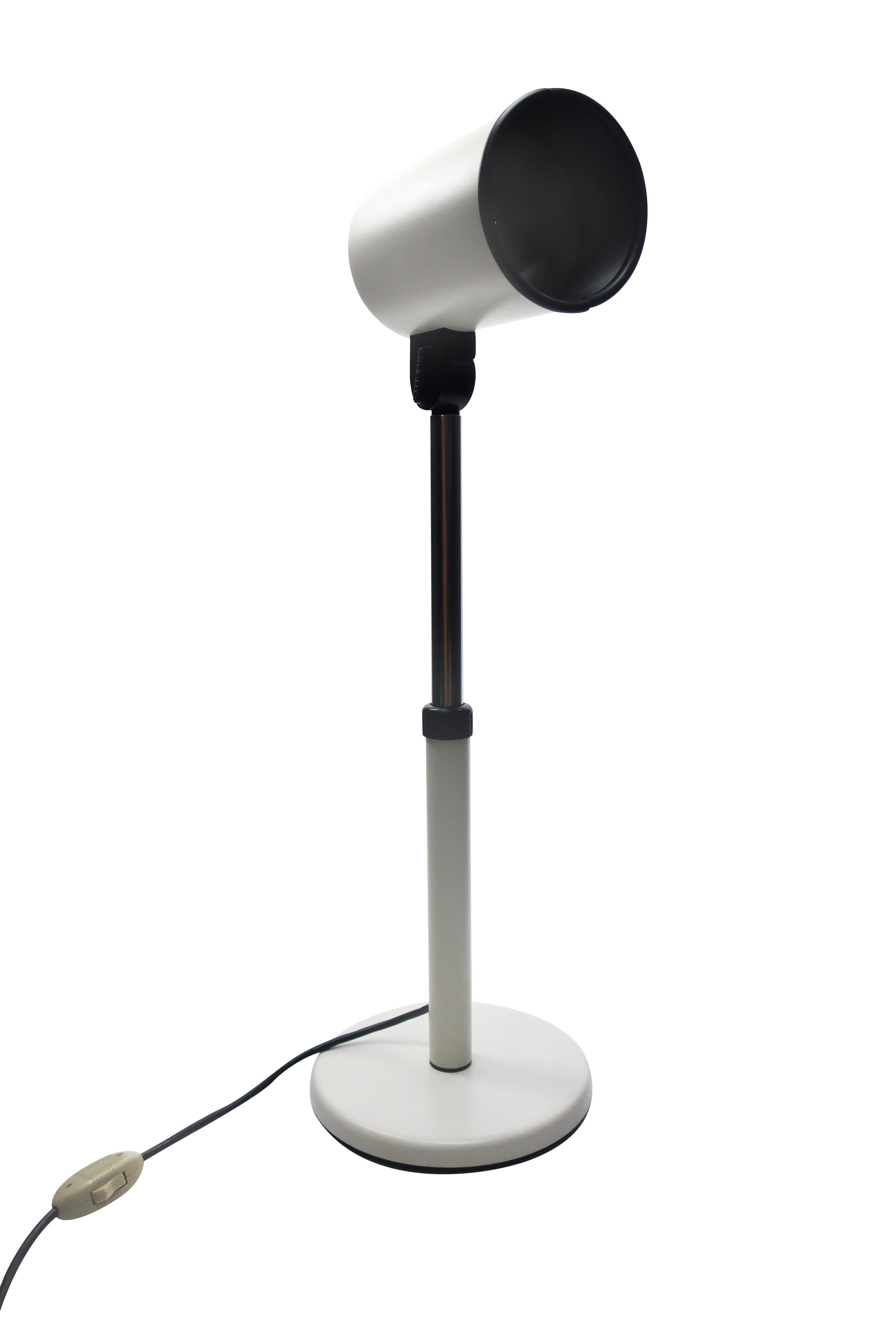 A vintage 1970s white Studio FPM table lamp that can be used as a desk lamp or accent lighting perfect for home or the office. White round metal base, white and chrome stem with black adjusters, and white metal shade with black accent. In excellent