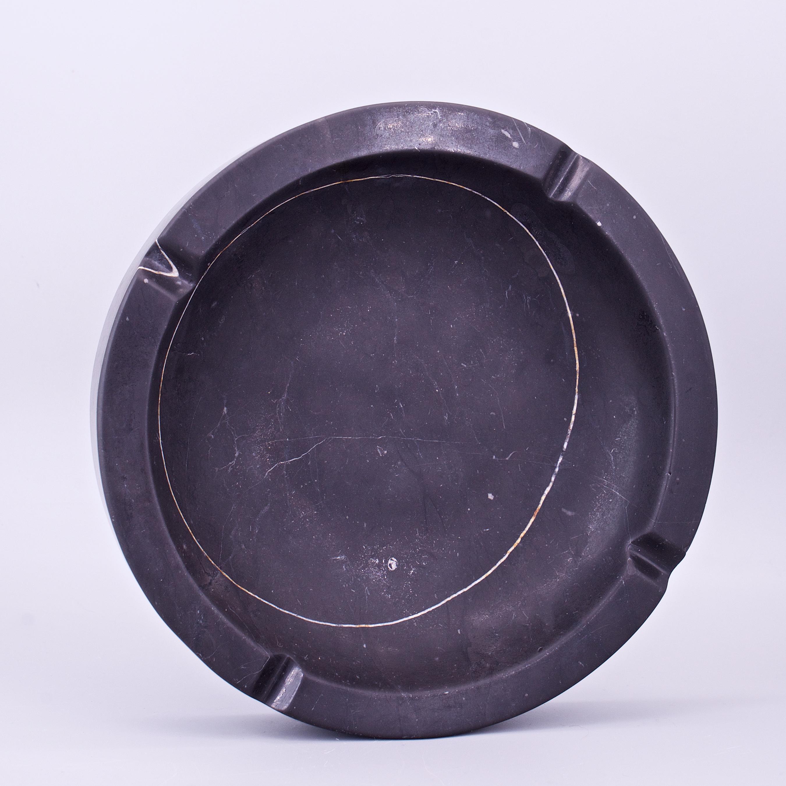 Carved out black marble ashtray, revealing nicely placed circular white veining. Has an imperfection / chip near one of the cigarette notches, shown in image 3, bottom left notch.