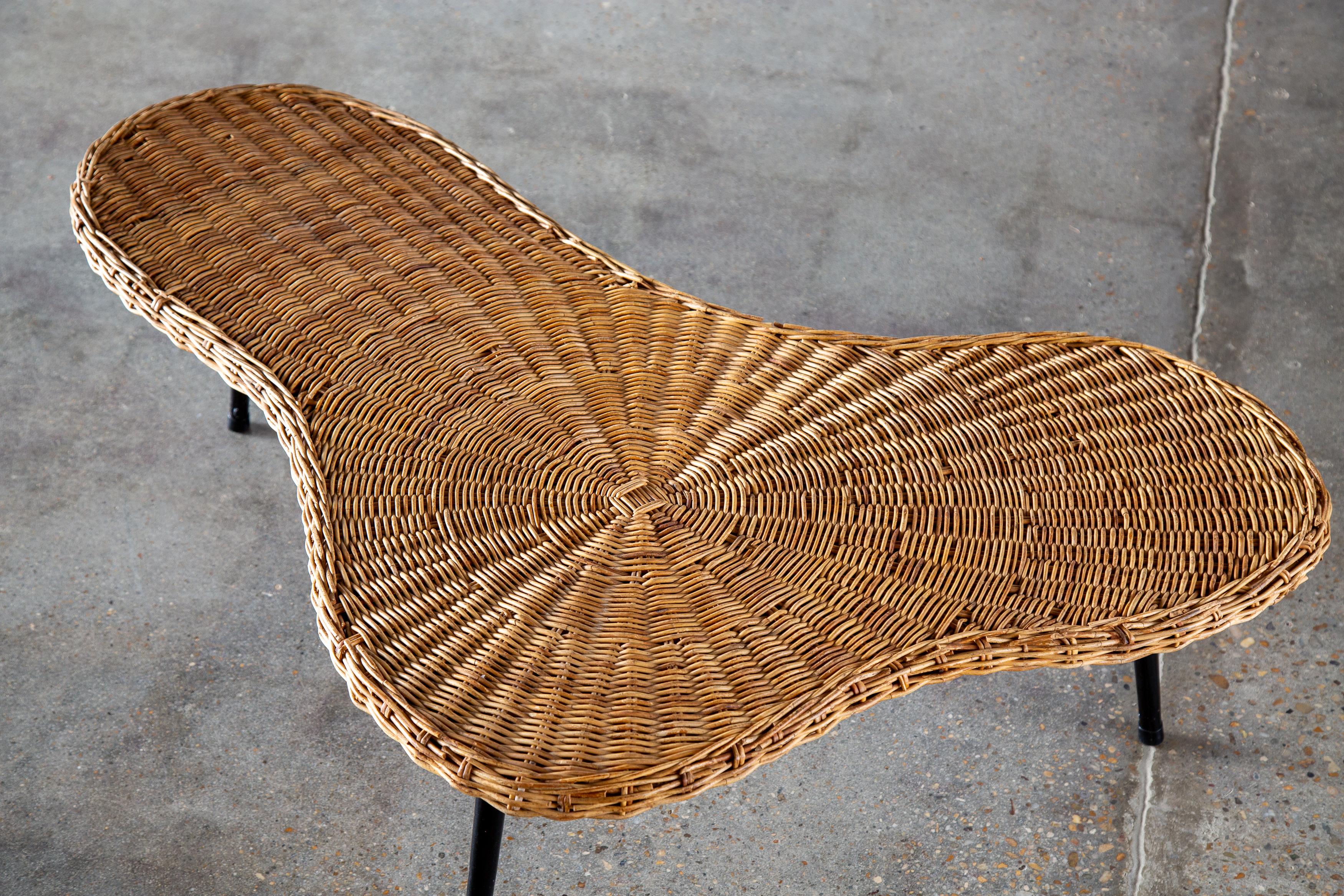 A 1970’s organic amoeba shaped coffee table featuring a woven wicker top on a solid pine base supported by iron legs.  Seemingly French, the top reminds us of Robsjohn Gibbings and Vladimir Kagan’s organic designs, with a Jean Tourret, Jean Prouve